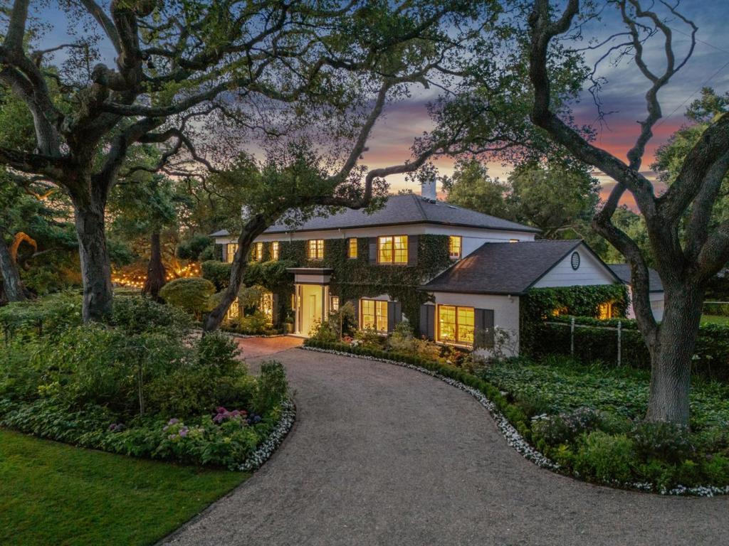 A rare and magical opportunity in the heart of Atherton - this extraordinary estate features a gorgeous traditional home on two contiguous parcels (.954 acre + .922 acre) providing ~two acres of limitless possibilities. A whimsical, park-like setting with exquisite landscaping distinguishes this as one of Lindenwood's finest. The main residence features 5 beds + office, 4 baths + 2 half baths. A grand two-story foyer with a spiral staircase leads into 4,410sf of refined living space. The living room boasts ~10 ft ceilings and a wood-burning fireplace, while the office offers built-ins and fireplace. The formal dining room showcases hand-painted walls. The chef's kitchen is equipped with Quartz countertops, stainless steel appliances, double ovens, and eat-in area. Quiet guest suite on main level. The family room opens to a private brick patio. Upstairs, 2 bedrooms share a private balcony, while another sits adjacent to spacious upper foyer. The elegant primary suite features dual walk-in closets, spa-like bath, and secluded balcony. Picturesque gardens are visible from every room. The estate's beautiful grounds include a broad brick entertaining patio, rose garden, pool, spa, pool house, irrigation well, 2 car garage, and circular driveway. An unrivaled Lindenwood offering!