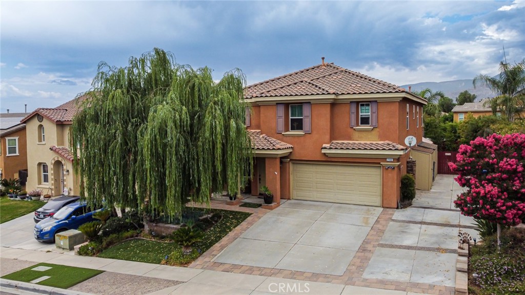 STUNNING MENTONE HOME – Located in a serene foothill neighborhood at the base of the San Bernardino National Forest, this unique property is ready for a family to call it home. Walking through the front door, you will immediately notice the custom upgrades and craftsmanship of work -- beautiful tile flooring, high ceilings, stone fireplace, crown molding, and a flowing floor plan that brings everything together. The kitchen includes wooden cabinetry with plenty of storage space, granite counter tops with full height tile back-splash, and stainless steel appliances. There is a downstairs bedroom and bathroom. Going up the mahogany staircase to the upstairs, you will find the other spacious bedrooms all featuring hardwood bamboo floors. The LARGE master bedroom feels like a suite, with an oversized walk in closet and its own private bathroom with shower and soaking tub. Furthermore, this home is perfect for entertaining -- enjoy your own private backyard oasis with lush mature landscaping and mountain views. Lastly, the property also includes a 2-car garage and RV parking on the side of the house. This one is turn key and ready to move in. Take advantage of this rare opportunity and make this custom home yours TODAY!!!