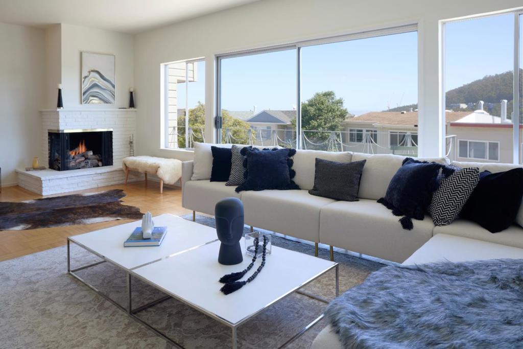 Welcome to this spacious 4-bed, 2.5-bath home in highly desirable Golden Gate Heights, with incredible views youll love seeing every day! The main level makes entertaining easy with the kitchen, dining room, and wet bar flowing together seamlessly, leading out to patios for outdoor dining and relaxing. Unwind by the warm gas fireplace in the living room or step onto one of the many balconies to take in the fresh air and stunning vistas of Twin Peaks and Sutro Tower. Upstairs, 4 bedrooms offer privacy and a quiet retreat. The primary bedroom features an ensuite bathroom with jacuzzi tub and skylights, generous double closets, and a private balcony with breathtaking panoramic views of the city and the bay. Additional features include: new paint throughout, modern lighting, refinished parquet hardwood floors, spacious closets, and skylights. Large 4-car garage with new polyaspartic floor, laundry area, ample storage space, and 200-amps for EV charger. Conveniently located near parks, playgrounds, UCSF, and the vibrant shops and restaurants of Irving St and West Portal, and so much more!