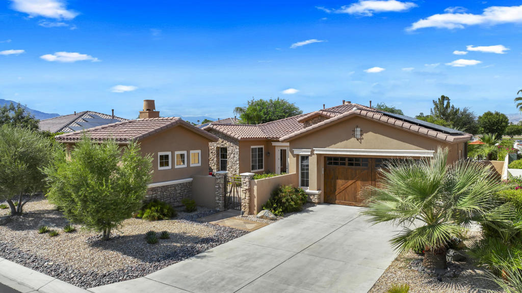 .....I realize there's a lot of information listed below, but I guarantee it's worth it!This private sanctuary of understated elegance, modern comfort, and sun-drenched tranquility is in this remarkable desert home. Perfectly positioned in an exclusive gated community nestled between the world-renowned Marriott Desert Springs Resort and the vibrant corridor of Hwy 111. This fully furnished, meticulously maintained residence is more than a house--it's an invitation to experience the best of indoor-outdoor living in a lush oasis setting.The home's expansive footprint includes an array of luxury amenities, tailored to embrace any unique lifestyle.* Chef's kitchen including a 5-gas burner cooktop, built-in wall ovens, wine fridge and walk in pantry. *10 ft ceilings with 8 ft doors throughout. *3 Bed/ 2.5 Bathrooms, including 2 en suite bedrooms and a spacious casita w/bath.*Built-in office space with custom cabinetry and pull-out couch for added sleeping flexibility*Travertine flooring throughout for timeless beauty and easy maintenance*Newer walk-in shower with frameless glass in the primary suite*3 AC systems plus a split A/C system in the garage for year-round comfort.If this isn't enough, the home has an ample amount of owned solar panels to help manage monthly cost. This home is an Entertainer's Dream,Imagine stepping into a backyard that feels like your own private resort. Designed for both grand gatherings and quiet moments, the outdoor living space is replete with thoughtful features that make it a destination in itself.Spillover Spa & Waterfall that flows gently into the gorgeous sparkling pool.Expansive Patio with Fireplace & TV: Enjoy year-round al fresco lounging and dining, game nights or movie marathons.Outdoor BBQ Kitchen: Cook and entertain with ease at the built-in BBQ station, complete with prep counter for your guests to gather 'round.Mist system with filtration: Stay cool even on the hottest summer days with a state-of-the-art mist system extending comfort across the entire back patio.Mature grapefruit, lemon, and tangerine trees grace the backyard, offering fresh fruit and fragrant blossoms throughout the year.Impeccably Manicured Yard: Professional landscaping, decorative plantings create a picturesque and private setting for recreation or relaxation.Don't miss out on this truly amazing home, call for your private showing today