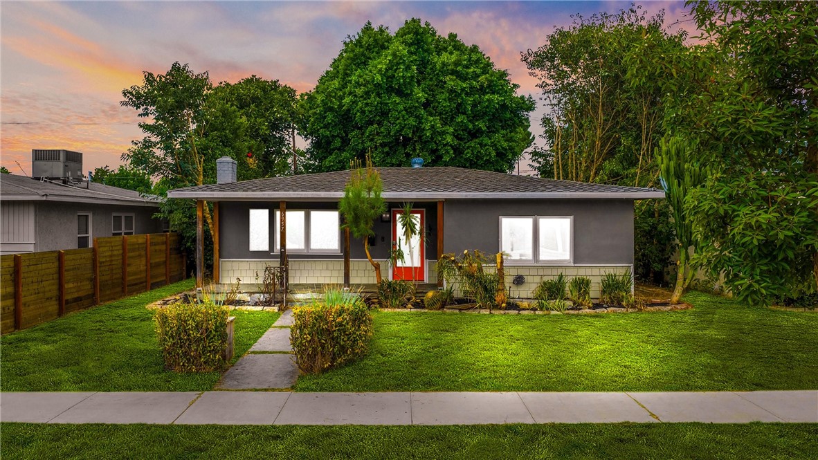 Charming single-story residence in the heart of Reseda offering a perfect blend of comfort, style, and functionality. This well-maintained home features 3 spacious bedrooms with ample closet space and one updated bathroom, thoughtfully designed with a walk-in shower, pedestal sink, and bold black fixtures. The inviting living room showcases a stone fireplace, recessed lighting, and large windows, creating a bright and airy atmosphere that flows into the dining area. French doors in the dining room open to a private backyard, perfect for entertaining. The updated galley-style kitchen boasts granite countertops, sleek black cabinetry, stainless steel appliances, and a stylish tile backsplash. A convenient laundry area provides direct access to both the kitchen and the backyard. The lush backyard is designed for both relaxation and gatherings. A spacious covered patio with a ceiling fan serves as an outdoor living room, ideal for morning coffee or year-round entertaining. The yard offers open green space, mature trees, and a charming pergola dining area, beautifully accented with string lighting for cozy evenings. In addition to its inviting outdoor amenities, this property offers ample functionality with a detached garage and an extra gated parking space accessible from the alley. This outdoor haven strikes the perfect balance of comfort, privacy, and practicality — ideal for first-time buyers, growing families, or anyone looking for a move-in-ready property filled with character and charm! Note: the photos of the front yard have been edited to include virtual grass. The backyard currently has artificial grass.
