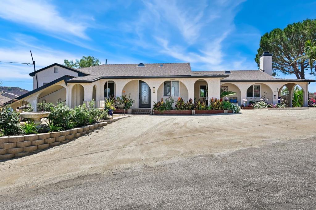 Experience the perfect blend of comfort, space, and views with this Lakeside hillside retreat on a sprawling 1.1-acre lot. This beautifully maintained home features paid solar, a sparkling pool, and a custom paver patio—perfect for outdoor entertaining. Inside, gorgeous red oak hardwood floors flow throughout the living areas, anchored by a cozy fireplace. The beautifully appointed kitchen boasts stainless steel appliances, granite countertops, and ample cabinet space. The primary suite offers generous closet space and its own en-suite bath. Enjoy stunning west-facing sunsets from your private backyard oasis and beautiful eastern sunrise views from the front of the home. The lower portion of the lot includes separate access, ideal for adding an ADU or workshop. Additional highlights include a detached 2-car garage below and an additional 1.5-car garage at the top by the house. Conveniently located near shopping, dining, parks, and Highway 67, this is a rare opportunity to own a private escape with endless possibilities!