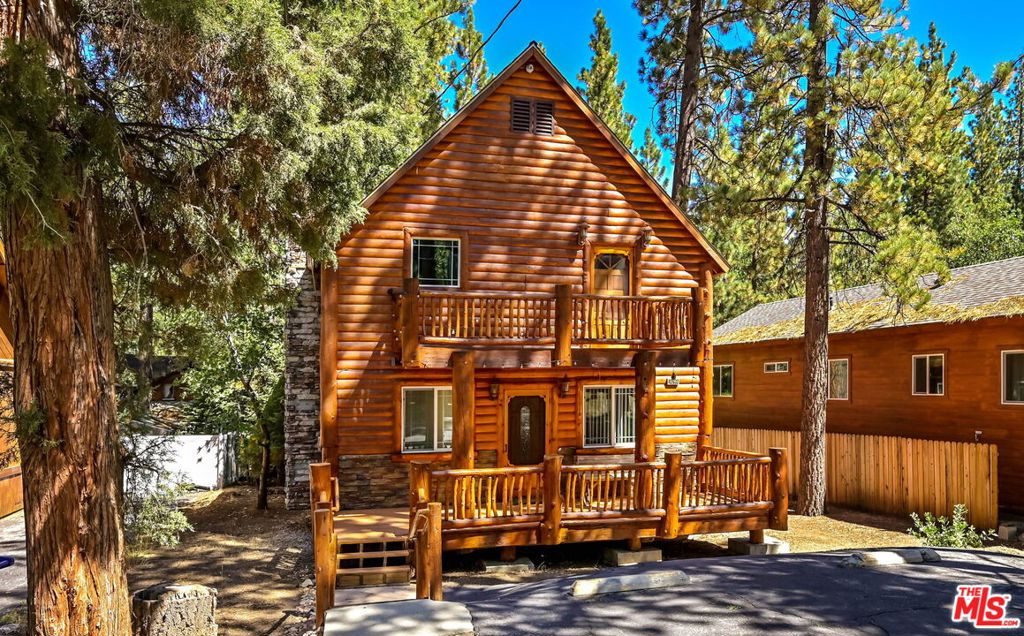 Tucked away in the desirable Lower Moonridge neighborhood of Big Bear Lake, this 3-bedroom, 2-bathroom cabin offers nearly 1,500 square feet of inviting mountain living. The open main living area features a fireplace and large windows that bring in natural light and forest views, while the spacious kitchen and thoughtful layout make it easy to enjoy time with family and friends. Upstairs, a second living room opens to a balcony where you can sip morning coffee and take in the crisp mountain air. A large backyard with an above-ground spa provides the perfect place to unwind after a day of outdoor adventure. Ideally located just minutes from Bear Mountain, Big Bear Lake, hiking and biking trails, and The Village's shops and dining, this cabin offers a true four-season lifestyle and is well-suited as a primary residence, vacation escape, or investment property.