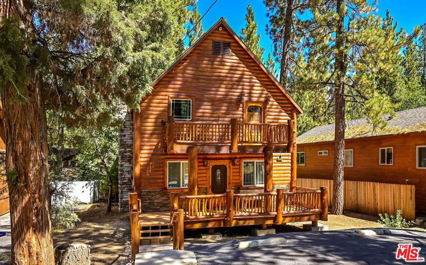 Tucked away in the desirable Lower Moonridge neighborhood of Big Bear Lake, this 3-bedroom, 2-bathroom cabin offers nearly 1,500 square feet of inviting mountain living. The open main living area features a fireplace and large windows that bring in natural light and forest views, while the spacious kitchen and thoughtful layout make it easy to enjoy time with family and friends. Upstairs, a second living room opens to a balcony where you can sip morning coffee and take in the crisp mountain air. A large backyard with an above-ground spa provides the perfect place to unwind after a day of outdoor adventure. Ideally located just minutes from Bear Mountain, Big Bear Lake, hiking and biking trails, and The Village's shops and dining, this cabin offers a true four-season lifestyle and is well-suited as a primary residence, vacation escape, or investment property.