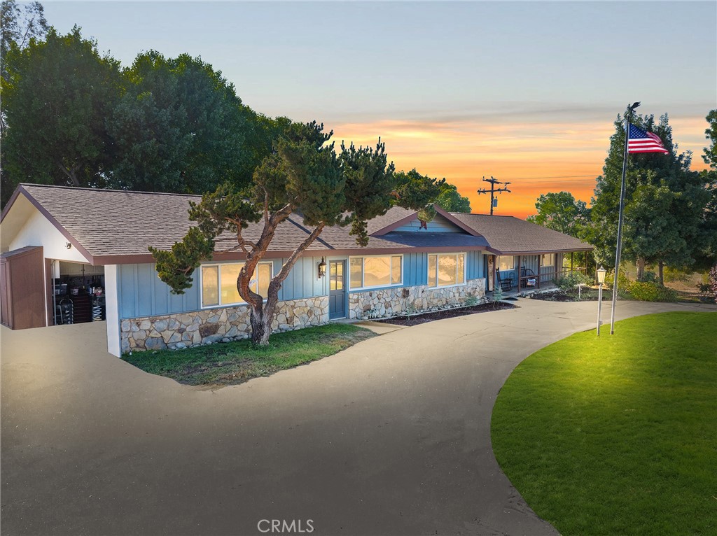 Discover the enchanting charm of this beautifully appointed farmhouse, nestled on over 67 acres of stunning agricultural land. Surround yourself with breathtaking landscapes adorned with majestic boulders, flourishing oak trees, and nature's own walking trails. Revel in the breathtaking sunsets, all just minutes from the renowned Temecula wine country and the serene Diamond Valley Lake.
Step inside to an inviting sunroom that bathes the home in natural light, complemented by a cozy wood-burning Franklin stove in the living area and a traditional wood-burning fireplace. The interior exudes warmth with original hardwood floors throughout, while the elegant en suite bathroom boasts a luxurious footed tub.
Venture outside to explore a delightful abundance of over 50 pomegranate trees, alongside a diverse grove of fruit trees—olives, mulberries, lemons, apricots, nectarines, and apples—together with flourishing Tannat grapevines. Experience the tranquility of the surroundings as you meander through shaded areas, well-tended garden beds, and discover two charming wooden work sheds, a bocce ball court, and a horseshoe court.
Imagine the joy of watching your ducks wade in the picturesque duck pond, with ample space for raising chickens and pigs in their very own coop, as well as designated dog runs. Your vehicles will find a secure home in the expansive gated area, equipped with an electric opening, perfect for RV storage.
This captivating outdoor entertainment area invites unforgettable gatherings, featuring a grand 32-foot dining table and a checkerboard area. Enjoy multiple patios, a dedicated BBQ pad, and a spa designed for relaxation.
This extraordinary property offers endless possibilities and is truly a rare find.