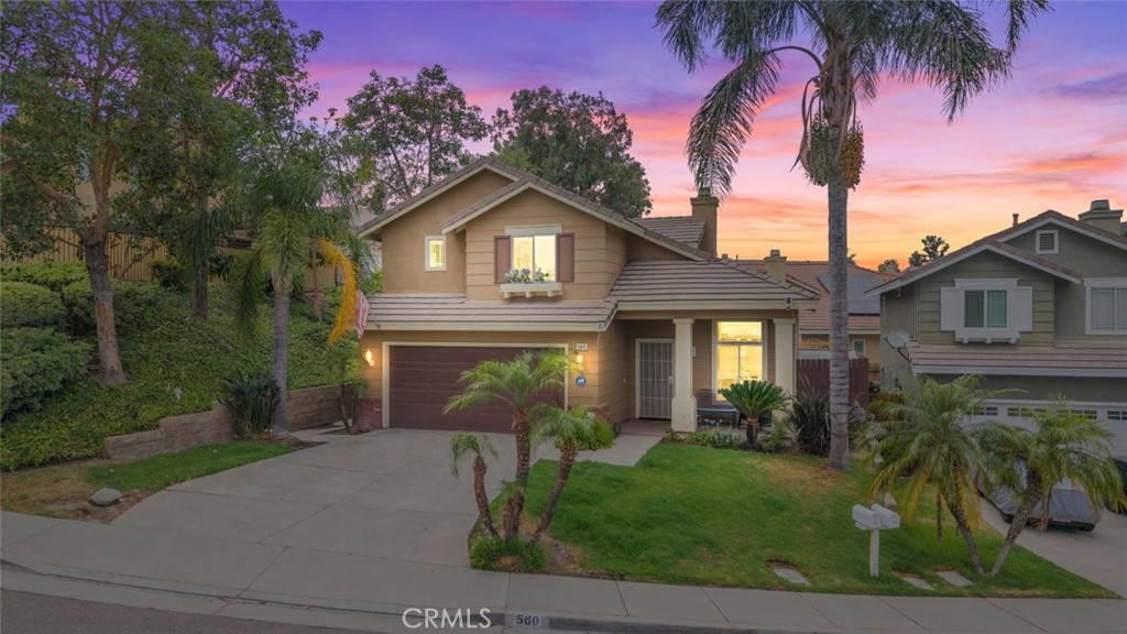 Welcome to 560 Shenandoah Road, Corona Hills — where timeless charm meets modern comfort.
Nestled in one of Corona Hills’ most tranquil and picturesque neighborhoods, this beautifully updated two-story traditional home now features stunning new flooring, fresh interior paint throughout, and modern recessed lighting that adds warmth and sophistication to every room.
This 3-bedroom, 2.5-bathroom residence includes a two-car garage with built-in storage, a stylish outdoor living space, and central air and heating for year-round comfort. Step into a bright, airy living room with soaring cathedral ceilings, expansive picture windows, and a seamless layout that opens into the family room and kitchen. The family room offers a cozy wood-burning fireplace and views of the covered patio and lush yard.
The kitchen continues to impress with recessed lighting, cream paneled cabinets, granite countertops, a glass tile backsplash, and stainless-steel appliances—all complemented by upgraded finishes and abundant natural light. From the kitchen, step out to the spacious backyard, featuring a covered patio with ceiling fans, an outdoor entertainment system, and a large grassy area perfect for hosting guests, relaxing evenings, or family playtime.
Upstairs, the master bedroom includes an en-suite bath and walk-in closet, while the additional bedrooms and guest bathroom are connected by a spacious hallway that houses a convenient laundry area. Every corner of the home reflects thoughtful upgrades and attention to detail.
And best of all, this location is ideal for Orange County commuters, offering swift access to both the 91 and 15 freeways—making daily travel a breeze while maintaining the peaceful charm of suburban living.
Residents enjoy neighborhood parks, scenic hill views, top-rated schools, and easy access to dining, shopping, and entertainment. Come experience the perfect blend of style, comfort, and convenience at 560 Shenandoah Road.