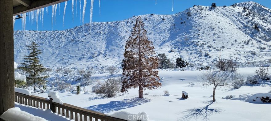 Close to ski slopes! Wellness, peace, and tranquility found here. Highly upgraded custom built home in a serene and private location. ON PAVEMENT and ON NATURAL GAS with PRIVATE WATER WELL. Enjoy four seasons and all the scenery that goes with! This property affords modern conveniences, combined with peaceful rural living. This property is well designed from the inside out. Driveway is completely gravel surfaced, and is accessed by paved Green Road. Triple driveway access allows for plenty of parking when entertaining, and also for RVs, toys, etc. Oversized two car garage with a work room located inside garage. The home has two entries, both with generous decks and ready for good old fashioned front porch sitting to enjoy this picturesque setting. Flooring inside is upgraded to Lifetime vinyl in the main living area. Open floor plan design with the wrap-around porch, plenty of indirect natural light enters the home. Dual heating, dual cooling systems with upgrades. Central air, central heat, with new attic ducting, evaporative cooler and cross-breeze design. If you’re new to the high desert, then you may not already know about the wonderful night time breezes, low humidity, and wonderful warm weather nights where you’ll enjoy allowing the screens to bring in a fresh breath of clean air. Central has heat plus a large freestanding wood burning stove, centrally located in the home, with a blower. Combined with a very large ceiling fan, and the design of the floor plan, the current owner uses this as the primary heat source in the winter. A corner fireplace in the primary bedroom suite adds cozy ambiance on winter nights. Split floor plan with very large primary suite with private deck access. En suite includes separate water closet, shower, soaking tub, and seated vanity. Plenty of built-ins, niches, and storage cabinets throughout the home so everything has its place Upgraded hall bathroom with wainscoting and upscale fixtures. Kitchen is dual tone custom cabinetry, granite sink, RO drinking water, instant hot water, and don’t forget that the house water is from a healthy well, and filtered through a Rainsoft water softener system. Upgraded appliances and fixtures. Walk-in pantry. Natural edge granite counters. Bedroom closets have custom built-ins. All bedrooms are quite large. Many other custom features which can be experienced with a private showing. Plan to spend a good while here when viewing as there is so much detail to learn about and appreciate.