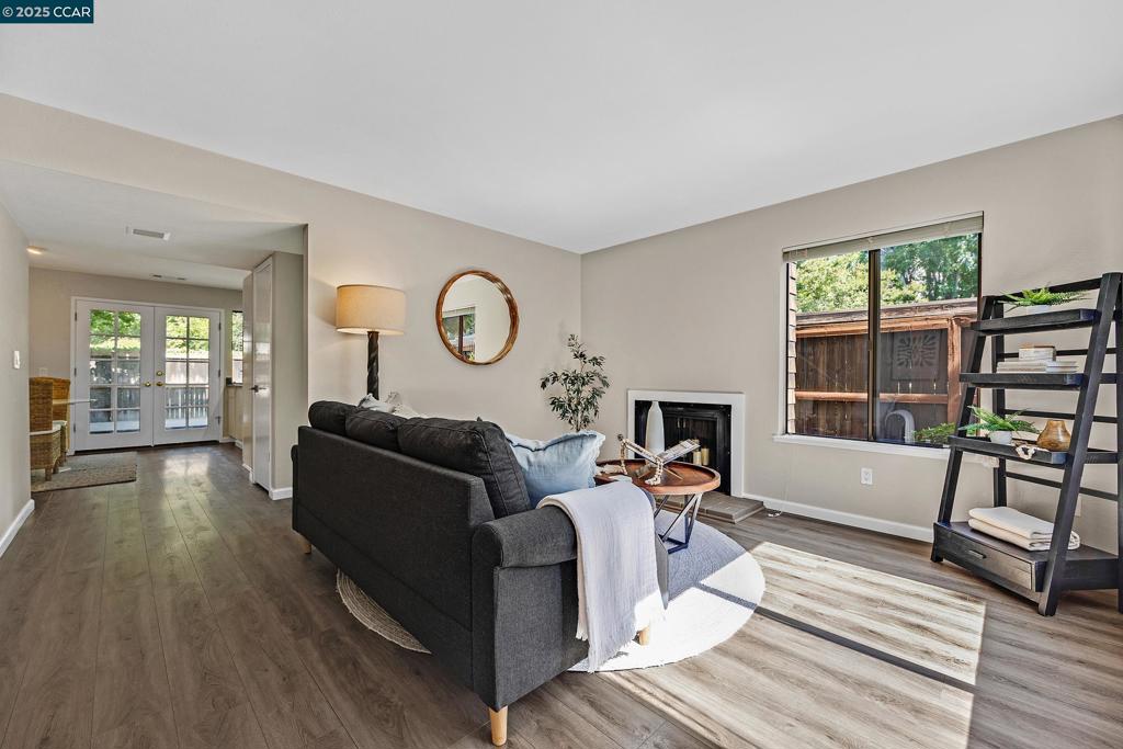 Located in the heart of the highly sought-after Honey Trail community, this charming corner-unit townhouse-style condo offers an unbeatable blend of privacy, space, and prime convenience. Just minutes from BART, the Iron Horse Trail, top-rated restaurants, shopping, freeway access, and downtown, the location truly shines. This light-filled 2 bedroom, 1.5 bathroom home features luxury vinyl plank flooring on the main level and upstairs hallway, paired with plush patterned carpet in the bedrooms for added warmth and comfort. The kitchen is complete with granite countertops, ample cabinetry, and stainless steel appliances. One of the standout features is the expansive backyard, one of the largest in the entire complex - ideal for outdoor entertaining, gardening, or simply relaxing in a peaceful setting. Enjoy an expansive patio along with a beautiful oversized deck. Additional highlights include in-unit upstairs laundry, two exterior storage closets, and two assigned parking spaces (one covered). With its rare combination of size, location, and setting, this Honey Trail gem is not to be missed!