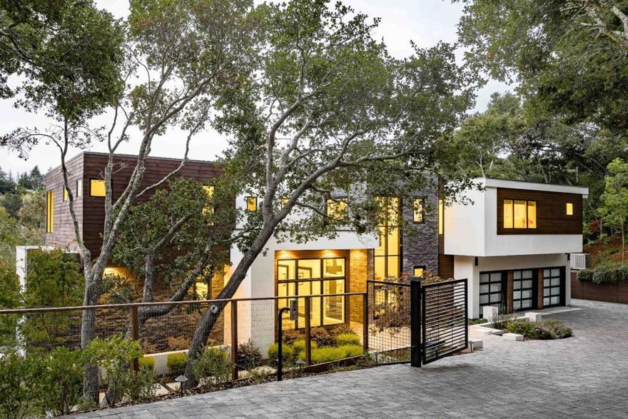This Hillsborough estate is a true masterpiece of contemporary design and craftsmanship. Nearly 5,700 sf of total living space. Spanning three levels, the home is filled with exquisite details and premium materials, with a bold use of glass that floods every corner with natural light. A magnificent great room, a gourmet kitchen, and an inviting family room provide ideal venues for both entertaining and daily life. Designed for seamless indoor/outdoor living, glass walls fully retract to reveal five-star grounds with an infinity pool, an outdoor kitchen, and patio space. Each bedroom is en suite, with the stunning primary suite boasting a fireplace and a private balcony, while the detached guest home provides an additional bedroom and bathroom. Conveniently close to downtown Burlingame, a prestigious country club, parks, SFO, and commute options. Additionally, families will appreciate access to top-rated public schools and nearby private institutions (buyer to verify eligibility).