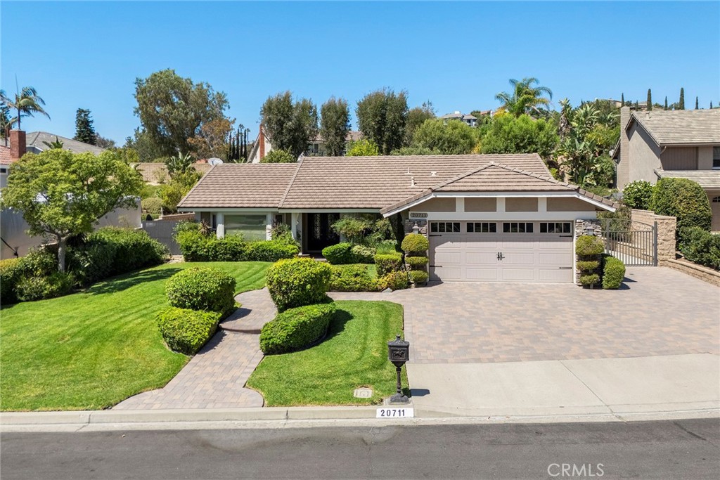 Spacious single-story home nestled on a quiet, peaceful cul-de-sac with extra space between homes making it perfect for privacy and a feeling of not feeling confined. This lot is just over a quarter of an acre and provides RV parking for the largest of RVs along the side. Curb appeal is incredibly attractive as you drive up with the house set back on the lot with an expansive of lawn in the front with pavers on the path to the front door and for the driveway enhances the appeal and provides for additional parking. Come on in through the double metal doors with glass inserts, impressive as an entrance. Once inside you feel the openness of the home with the living room and dining room visible to the kitchen and the family room. Looking out the front bay window from the living room gives you a good feeling of the neighborhood and your home. As you continue to look around you, you will notice the luxury vinyl flooring that covers the interior, a desirable quality in today’s market. A cathedral ceiling awaits you in the family room which also has a stone covered fireplace. The kitchen is the heart of any home, and this one is ready for you with granite countertops and backsplash, a Monogram 5-burner range and vent hood, a built-in refrigerator, a microwave, dishwasher all stainless-steel appliances. Great storage and a pantry complete the kitchen. Ceiling fans are throughout the home for comfort and cooling. There are three bedrooms in this lovely home and magnificently done. Two bedrooms share the remodeled hall bath with granite counters and dual sinks as well as a tub/shower combo. The primary bedroom is elegant and gives you the view of the backyard. Then, the primary bath has been remodeled with granite counters and dual sinks, a walk-in closet, a separate room with a walk-in shower and the toilet. Beautifully done and ready to move it for the buyer. Going outside and you see two large cabanas with tile roofs and sitting on raised trex-like decking ready for your next party or just a place to have a quiet meal with friends. Plenty of grass area as well in this well-manicured backyard. Already mentioned is the RV parking on the side that could fit a forty-foot RV. A perfect location in Yorba Linda and excellent schools, this one is a must see!