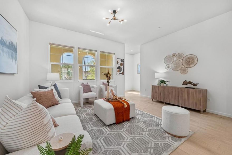 This highly sought-after 4-bed, 3.5-bath townhome offers over 2,100 sq ft of light-filled living space in a newer community with beautifully landscaped surroundings. The open-concept main level showcases soaring ceilings, a spacious living/dining combo, and a gourmet kitchen with stainless steel appliances, gas cooktop, granite countertops, and a covered balcony for year-round enjoyment. Brand-new luxury vinyl plank flooring flows throughout, while the primary suite features a private balcony, spa-like en-suite bath, and generous walk-in closet. A first-floor bedroom with an attached bath provides excellent flexibility perfect for guests or rental income. Additional highlights include LED recessed lighting, a dedicated laundry room, and a tankless water heater. Ideally located near shopping, dining, and top-rated schools with easy access to 880, 84, and 680, plus major employers like Tesla, Meta, Kaiser, and Costco this home is the perfect blend of modern design, comfort, and convenience.