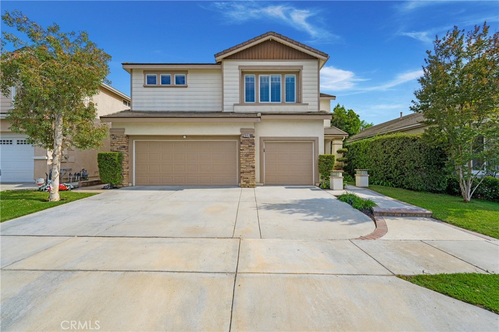 BEAUTIFULLY STRUCTURED TWO-STORY BREA HOME! SPACIOUS 3-CAR GARAGE! DISNEYLAND FIREWORKS & CITY VIEW! Welcome to this well-designed 5-bedroom, 3-bathroom home in the heart of Brea. From the moment you walk in, you're greeted by an open layout that seamlessly connects the living and dining rooms, wrapping around to the kitchen, main floor bedroom, and finally leading back to the front entrance. The space is accentuated by high ceilings, dual-pane windows, and recessed lighting that fills the home with natural light. The main floor features a versatile bedroom with a nearby full bathroom—perfect for guests or multi-generational living. Upstairs, open your door to a one-of-a-kind bedroom and loft combination, separated by an arched entry and a statement wooden sliding door—ideal for a private retreat, home office, or bonus room. Down the hall, several well-sized bedrooms share a beautifully designed bathroom with dual sinks and a glass-enclosed shower. The show-stopping primary suite is a true sanctuary, featuring a lounge area framed by elegant built-in columns, large windows with panoramic city light views, and a front-row seat to Disneyland fireworks every night. The luxurious ensuite bathroom includes a soaking tub, walk-in glass shower, private toilet room, and a spacious walk-in closet with built-in shelving and tiered rods. Back downstairs, enjoy a separated living room, formal dining room, and cozy family room with a decorative fireplace, along with a laundry room equipped with built-in cabinetry for added storage. The kitchen offers abundant white cabinetry, stainless steel appliances, a center island, and extra bar-height counter seating—perfect for entertaining and everyday use. Step outside to your open backyard patio, featuring privacy fencing on the sides and open fencing at the back to showcase the city views and let in the refreshing breeze. The attached 3-car, 2-door garage includes a 220-volt outlet for electric vehicle charging and a spacious driveway for additional parking. Not to mention even more built-in cabinetry within the garage for added storage space. An outdoorsy person’s dream, this home is just minutes from Brea Sports Park, Olinda Ranch Park, Carbon Canyon Regional Park, Wildcatters Dog Park, as well as nearby grocery stores, restaurants, and more. Proudly located within the top-rated Brea Olinda Unified School District, as well. Don’t miss out—schedule your private showing today!
