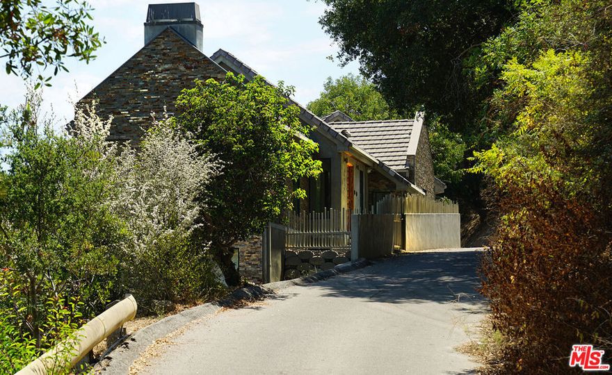 Luxurious Hillside Retreat on Iconic Cielo Drive  Perched behind gates on the storied Cielo Drive, this stunning hillside residence offers privacy, designer interiors, and sweeping canyon views in the coveted Beverly Hills Post Office area. Recently reimagined by acclaimed Beverly Hills interior designer Brigette Romanek, the home exudes modern sophistication and is available fully furnished (furnishings sold separately, artwork excluded) for a seamless, swift close. From the moment you enter, natural light pours through expansive view-facing windows and glass doors, creating a harmonious indoor-outdoor living experience across most rooms. The dramatic chef's kitchen flows effortlessly into a spacious great room anchored by a sleek fireplace, perfect for entertaining or relaxing in style. Downstairs, discover a serene primary suite along with two additional bedrooms and bathrooms, each bedroom opening to tranquil outdoor spaces overlooking the canyon. One level below offers a flexible space ideal for a gym, office, or studio, plus ample storage and access to a large lower lot terrace, with room to add a pool and create your own private oasis. Located just minutes from the world-class shopping and dining of the Beverly Hills Triangle, and with easy access to Sherman Oaks and the San Fernando Valley, this Benedict Canyon stunner blends luxury, privacy, and convenience in one extraordinary package. Live the Luxe Life on Cielo Drive.
