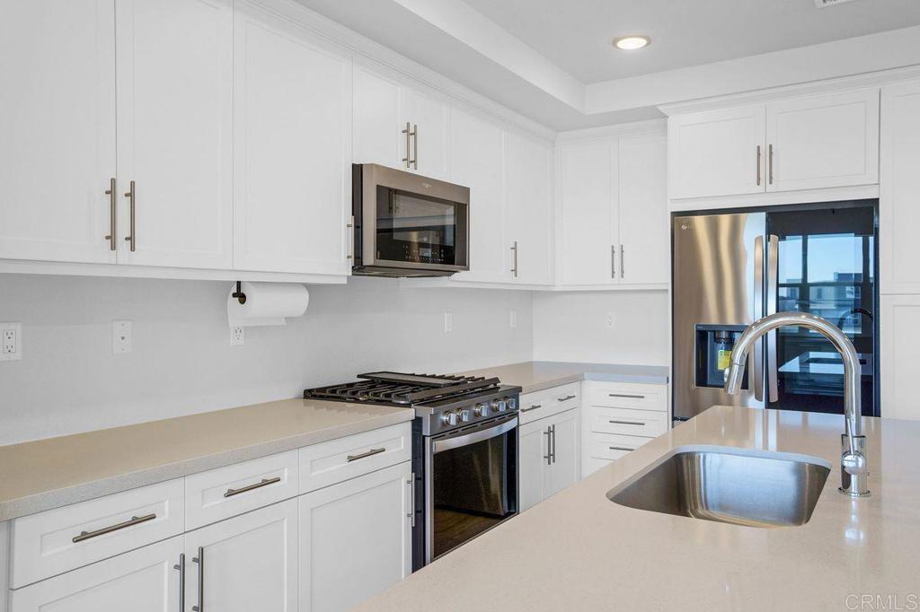 Discover Modern Living in the Heart of Millenia This stunning, like-new, 2-story townhome offers 3 spacious bedrooms and 3 full baths, providing both comfort and convenience. Enjoy the flexibility of having a bedroom and full bath on the 1st floor, perfect for guests or those seeking easy access. The master suite features a walk-in closet, and an additional bedroom is also located on the main floor for added privacy. The home boasts upgraded flooring throughout, newer appliances and a stunning open layout that highlights the modern design and craftsmanship. Relax on the balcony in the living room, where you can take in breathtaking views of the community park and mountains. This home is within walking distance to shops, schools, Otay Ranch Mall, and more, offering the perfect balance of tranquility and accessibility. Enjoy access to the resort-style pool and all amenities offered by the HOA, including parks, dog parks, and a brand-new community pool. Included with rent. This home is available now, unfurnished. Tenant responsible for all utilities and must carry renters insurance. Live in the cutting-edge Millenia community, where modern living meets convenience.