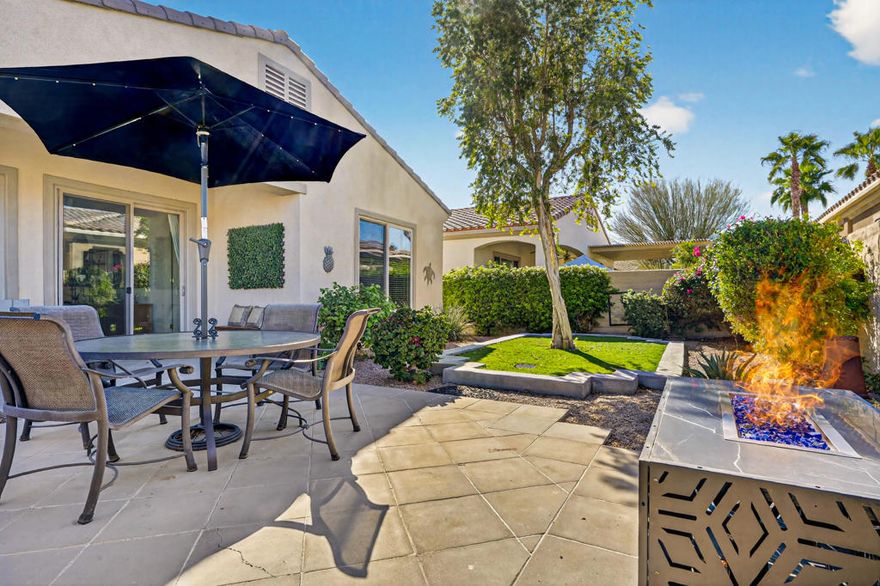 Welcome to this charming Canterra floor plan offering 1,257 sq. ft. of comfortable living space, ideally situated on a desirable corner lot in Sun City Shadow Hills. The inviting great room features tile flooring, two large windows, and a sliding glass door that fills the space with natura light and provides easy access to the backyard. The kitchen showcases sleek stainless-steel appliances, granite countertops, and abundant cabinetry with room for a cozy breakfast nook. A separate laundry room adds everyday convenience. The primary suite offers carpet flooring, a large picture window overlooking the backyard, a walk-in closet, and an en suite bathroom with dual vanities and a shower stall equipped with grab bars. The guest bedroom is located near a full bath with a shower-over-tub combination perfect for visitors. Step outside to enjoy a spaciousbackyard featuring a covered patio, firepit, extended concrete area ideal for outdoor seating, and a grassy section with a mature tree creating a relaxing retreat for entertaining or unwinding. Sun City Shadow Hills is an active 55+ community offering resort-style amenities, including two clubhouses, championship golf courses, fitness centers, pools and spas, pickleball and tennis courts, and a variety of social clubs and activities designed for every interest. Enjoy the perfect blend of recreation, relaxation, and connection in this vibrant desert community. Don't miss the opportunity to make this inviting Canterra yours!