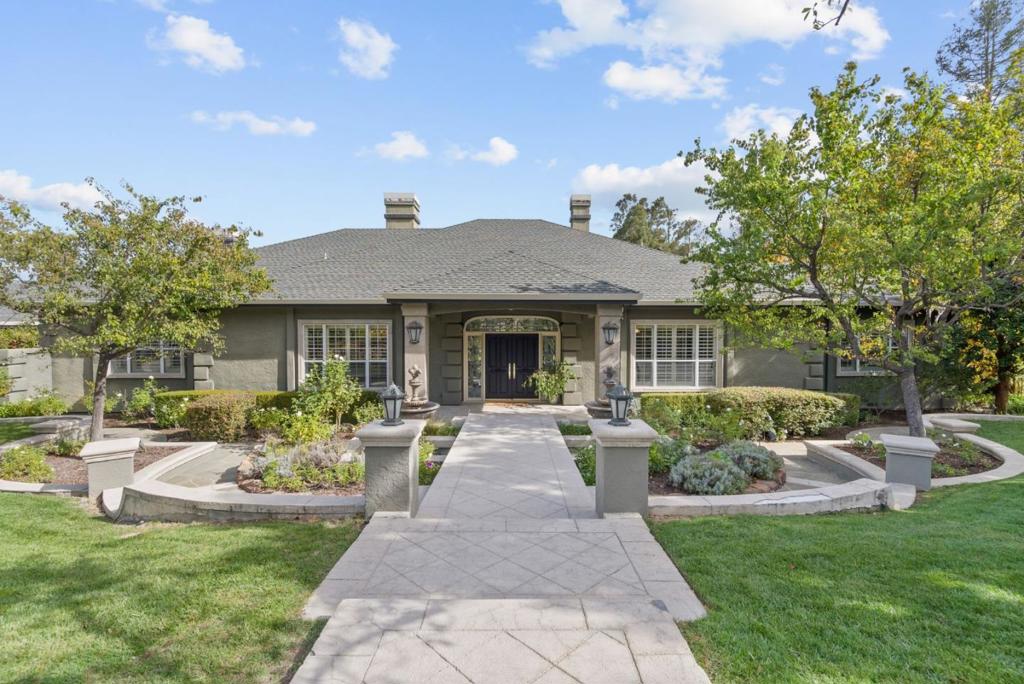 Welcome to luxurious living in the heart of Monte Sereno. This stunning 5,008 sq ft home, on one level, sits on a sprawling 44,000 sq ft lot. A separate guest house of over 700 sf is perfect for long term visitors. Each sumptuous room is a statement in itself. The living room looks out to the beautiful veranda and grounds, and a classic library boasts warm wood cabinets and its own fireplace. Note the gathering room with bar and cable-ready entertainment center and fireplace. A massive kitchen, laid out for chefs, includes two walk-in pantries, island with prep sink, breakfast bar, and a solarium dining area. There are 4 spacious bedrooms in the main house, including a luxurious primary retreat that must be seen. The 3 additional bedrooms are each a separate statement of quiet elegance.3-1/2 baths in the main house include the primary, a shared bath, a guest-wing bath and a powder room. Note the large laundry room. The grounds are beautifully landscaped and include a tennis court, swimming pool with spa, hot tub, a putting green, and a vineyard! There is a 4-car garage plus driveway space for 4-6 cars to park. A built-in vacuum, two HVAC zones, solar panels, permanent generator, security system and security gates complete the fabulous features of this stunning home.