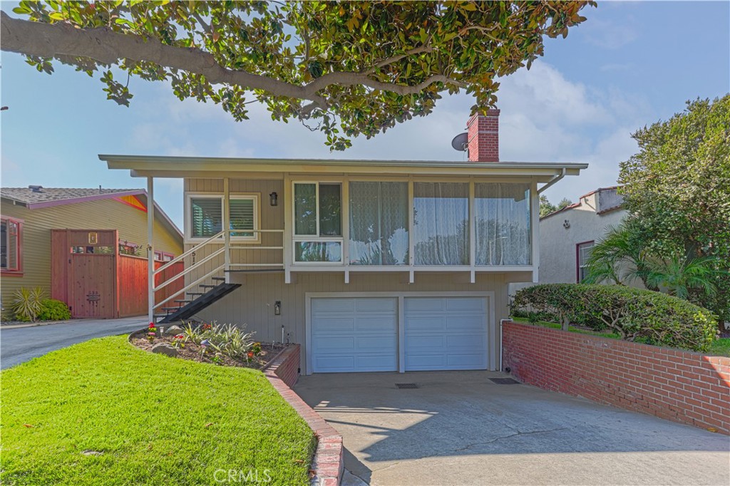 Rare Two on a Lot in Prime Historic Torrance Neighborhood – Live in One, Rent the Other!
Opportunities like this don’t come around often. Situated in one of Torrance’s most sought-after historic neighborhoods, this unique property offers two separate homes on one lot, perfect for multi-generational living, rental income, or a flexible work-from-home setup.
The spacious front home offers approximately 2,000 square feet of well-designed living space, with three bedrooms and two beautifully updated bathrooms. Step inside to a large open-concept living room featuring a striking stone-accented fireplace and stunning floor-to-ceiling windows that frame tranquil views of the lush Palm Tree Triangle, with no neighbors directly across the street. The space flows seamlessly into a remodeled kitchen adorned in warm neutral tones with white cabinetry, stainless steel appliances, recessed lighting, and a generous island offering bar seating and extra storage.
Vaulted wood-beamed ceilings enhance the inviting atmosphere, and the adjacent dining area is perfect for entertaining. Down the hallway, you’ll find two comfortable bedrooms and a remodeled full guest bath, along with a spacious primary suite featuring a walk-in closet with custom built-ins and an en-suite bath that has also been tastefully updated. A separate laundry room opens to the backyard, where you’ll discover a combination of grassy areas and hardscape, ideal for outdoor dining or relaxing in the garden setting.
Below the main living space, a large family room provides even more flexibility for lounging, working or entertaining. There’s also an oversized two-car garage with a workshop and an additional driveway on the left side of the home, offering ample room for auto enthusiasts, recreational vehicles, or extra guest parking.
The rear apartment sits above a second two-car garage and offers its own private entrance off the alley. This charming one-bedroom, one-bath unit features approximately 680 square feet of living space, along with a private deck and updated interior finishes that blend timeless hardware and neutral colors. Below the apartment is a versatile bonus room of approximately 10 by 20 feet, a perfect spot for a home office, gym, art studio, or music room.
Ideally located close to parks, award-winning Torrance schools, dining, shopping, and all the charm of Old Town Torrance, this rare property offers flexibility, functionality, and timeless appeal in an unbeatable location.