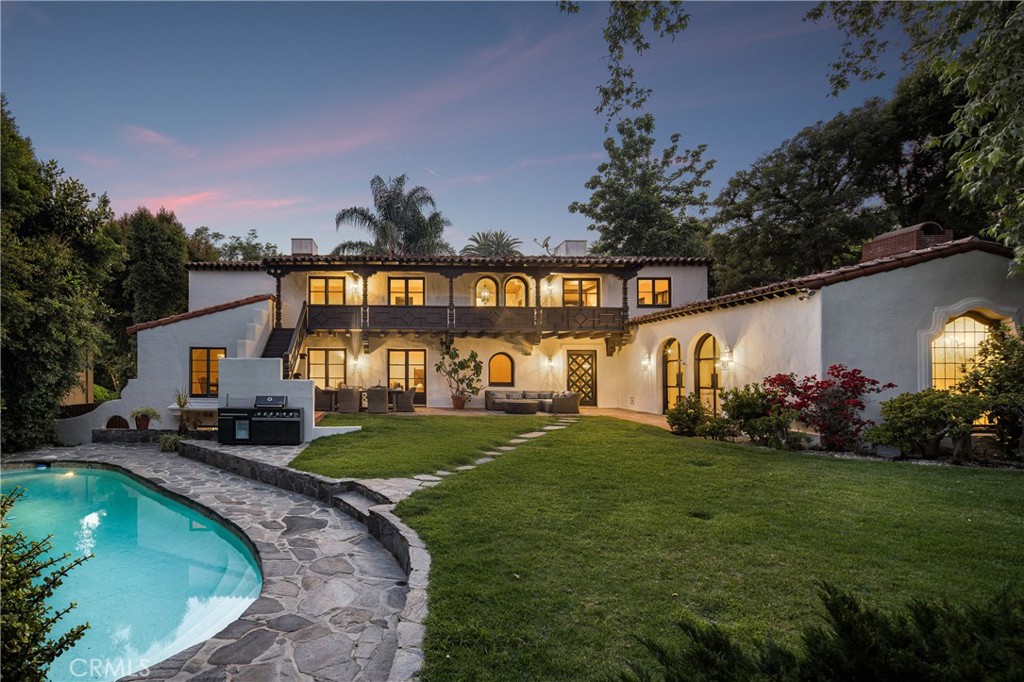 Welcome to a once-in-a-generation opportunity to own one of Hollywood's most iconic estates. Nestled in coveted Outpost Estates, this 1929 Spanish Colonial Revival masterpiece was the longtime residence of legendary host Bob Barker. Restored and reimagined by acclaimed designer Julia Dempster, it embodies the romance of Old Hollywood with the sophistication of contemporary luxury. Built atop the site of "The Outpost," the adobe home that marked Hollywood’s birth, this landmark is Los Angeles Historic-Cultural Monument No. 673. With a provenance as rich as its design, 1851 Outpost Drive is more than a home; it is a chapter of Los Angeles history. The estate features six spacious bedrooms, six baths, and a powder room. A 601 sqft basement includes a sauna and two additional rooms ideal for guests, office, or gym. A stylish home office with en-suite bath doubles as a guest suite or studio. Original details have been preserved, from the fresco ceiling and arched doorways to stained-glass windows and the iconic bar in the wood-paneled library. The dramatic fireplace and sweeping interiors evoke Hollywood grandeur. Dempster’s restoration brings natural textures and warmth, with Roman clay and limewash finishes enhancing the light. The chef's kitchen is a masterclass in form and function, with custom oak cabinetry, Thermador appliances, and breathtaking Viola Monet marble. The home offers two primary suites: the main with dream walk-in closet and his-and-hers baths, and a second with dual closets for guests or family. Bathrooms showcase book-matched travertine showers and marble thresholds. European oak floors run seamlessly, while hand-selected Zia tiles add character to the secondary baths. An infrared sauna offers a serene wellness retreat. Outside, the grounds feel like a private resort: pool, expansive lawn, and a towering oak tree create a sanctuary just moments from Runyon Canyon, the Sunset Strip, and the pulse of Hollywood. With its location, history, and world-class design, 1851 Outpost Drive is not simply a residence; it is a legacy awaiting its next custodian.
