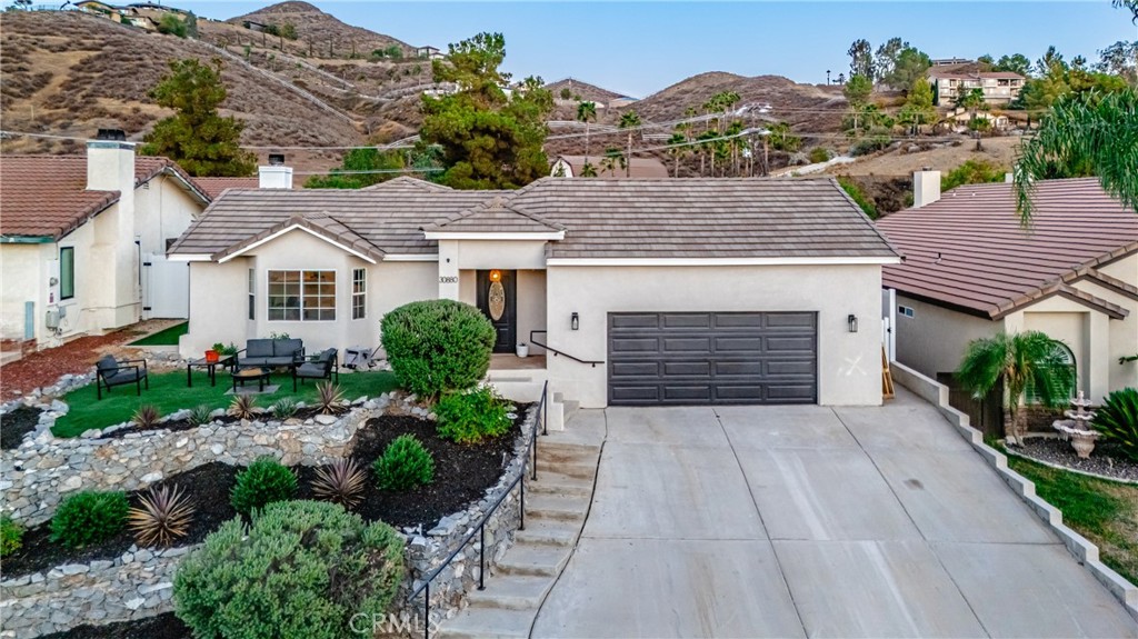 Beautifully single story, tastefully remodeled 3-Bedroom home plus BONUS ROOM full of modern touches throughout! Welcome to the sought after community of Canyon Lake. Step into this stunningly updated 3-bedroom home featuring a beautifully remodeled kitchen designed with neutral tones, custom cabinetry, sleek countertops, and a stylish backsplash that adds warmth and sophistication. Ideal for both everyday living and entertaining. Relax in the inviting living room complete with a cozy fireplace and an open layout ideal for gatherings with plenty of natural light. This home also includes a bonus oversized room, accented with stylish barn doors and a custom entertainment center, offers versatile space for a home theater, office, or playroom.
The bedrooms offer custom accent walls that add character and style. The spacious primary suite includes a freshly renovated private bathroom with elegant finishes and modern fixtures. All the rooms have ceiling fans and new flooring. Outside, the low-maintenance turf backyard features a charming gazebo, ideal for relaxing or entertaining. Residents of Canyon Lake enjoy access to a private lake, golf course, pool, clubhouse, tennis courts, equestrian center, parks, a gated community and more.This home combines charm and modern convenience, making it the perfect space to live, relax, and entertain. Don’t miss out on this move-in-ready gem!