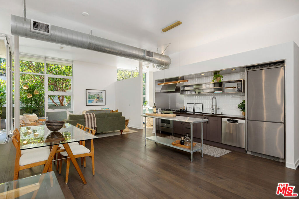 Modern Loft Living in the Heart of the Marina Arts District! Welcome to Gallery Lofts where clean, modern design meets the creative energy of one of Marina del Rey's most vibrant neighborhoods. This stunning 2-bedroom, 2-bathroom ground-floor unit offers nearly 11-foot ceilings, expansive floor-to-ceiling windows, and oversized Fleetwood sliding doors that flood the space with natural light and create seamless indoor-outdoor flow to a private ~280 SF balcony lined with lush palms. Designed with a contemporary open-concept layout, the sleek kitchen features stainless steel appliances, while the oversized primary suite boasts a custom walk-in closet and a luxurious bath with soaking tub and separate glass shower. Additional highlights include: *Hardwood flooring *Central A/C & heat *Upgraded shower fixtures in primary bath *Closest systems *Brand NEW water heater *In-unit laundry *2-car parking & ample guest parking Gallery Lofts offers residents a peaceful, artfully landscaped community with a serene outdoor lounge, BBQs, and a double-sided fireplace perfect for entertaining or unwinding.All of this just minutes from Abbot Kinney, Playa Vista, the beach, bike paths, shops, restaurants, theaters, grocery stores, and everything Marina del Rey has to offer! **Developer quoted approx. 1,340 SF; LA County Assessor shows 1,260 SF**