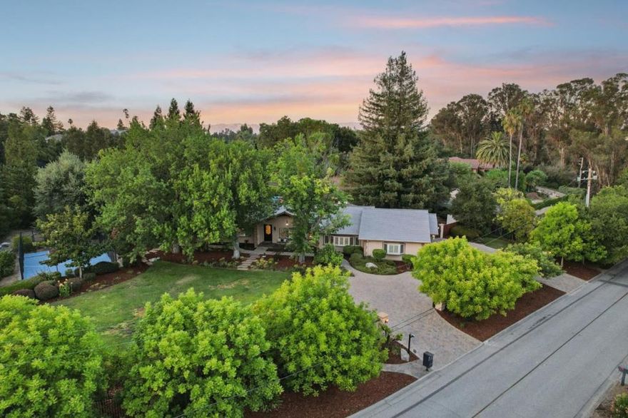 Welcome to 18801 Ten Acres Rd, Saratoga! Come see this beautiful single-story home on over 1 acre in the Sobey neighborhood with excellent schools! Step inside the foyer to discover a spacious, open layout with vaulted ceilings and plentiful sunlight. The gourmet kitchen features granite countertops, custom cherry wood cabinetry, and stainless-steel appliances. The master bedroom suite is palatial with its own fireplace, walk-in closet, and spa-like bath. Amenities include central air conditioning and heating; tankless water heater; buried utility lines; fully owned solar panels; wood-encased, copper-topped bay windows throughout; three-car garage; finished attic above garage with its own skylight; seismic safety upgrades; rebuilt in 2007, and much more! The grounds include a sport court, barbeque, heated pool and spa, playhouse, play structure, automatic sprinklers, lighted pathways, and landscape lighting. Chinese pistache trees, Japanese maples, magnolia, fragrant roses, lilies, flowering bushes, ornamental grasses, and fruit trees (jujube, pluot, pomegranate, mandarin orange, apple, limes, lemons, and more) have been planted to provide year-round botanical interest and seasonal colors. The property is fully gated and fenced in, with a U-shaped paver driveway. 2007 rebuild.