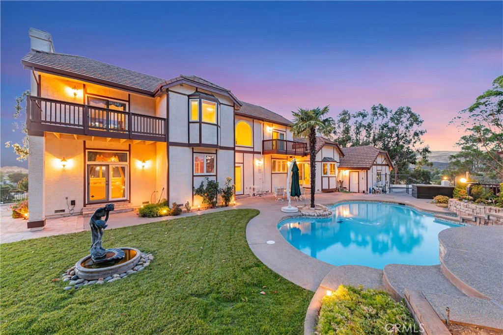 Welcome to the ultimate lifestyle of privacy and serenity. Perched atop a private 2.1-acre hilltop with plenty of leveled buildable land, an escalating private driveway with mature eucalyptus and fruit trees and breathtaking long distance sunrise sunset views, this custom English-inspired estate blends timeless craftsmanship and breathtaking 360 degree views from every window and terrace. The 4-bed, 2 full, 2 half bath home, features a dramatic spiral staircase with hand-forged iron railing upon entry, rich marble flooring throughout the main level, elegant details including leaded glass, crystal chandeliers, and three marble fireplaces, and spacious areas with privacy from every room. The formal living and dining rooms provide classic entertaining space, while a downstairs room allows for a private office or an optional guest bedroom flexibility. The expansive family room impresses with coffered ceilings, hidden automatic theatre screen and surround sound speakers, a custom walk-around wet bar great for entertaining and parties, and one of three classical fireplaces. A chef’s dream kitchen features mahogany cabinetry, granite countertops, high-end updated appliances and 6 burner stovetop, a large island with sink, plenty of dining storage, and a sunny spacious breakfast nook with views. Second story features the luxurious large primary suite with a sitting area and a cozy fireplace, joined by two well-sized guest bedrooms and balconies. Recent upgrades include thermal windows, upstairs carpet, kitchen appliances, and fresh interior/exterior paint. Step outside to enjoy multi-level front and back terraces, an enormous patio gazebo with an outdoor kitchen area, a newly plastered custom pool with a solar heating system, a lush grassy yard with stone finishes, all surrounded by mature trees and endless unobstructed meditative views. Lot includes a full acre of county-approved building and land surveys with environmental clearance to expand the main house to total 8 bedrooms or a second ADU or JADU dwelling sized at 1,700 sqft. Land for horses, vineyards, or orchards, with a 3-car garage and ample parking for entertaining and guests. This one-of-a-kind property offers the ultimate privacy and luxury lifestyle all within minutes from the local amenities of Almaden Valley.