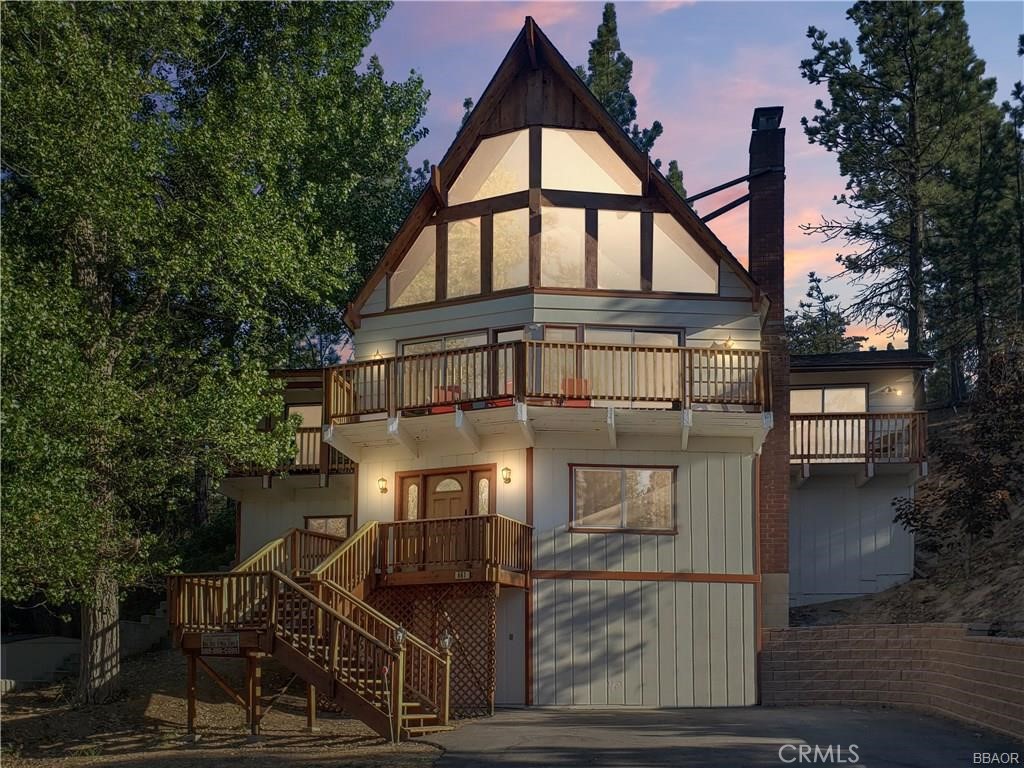 A classic mountain A-frame with a touch of chalet charm, this 3-bedroom, 2-bath home is positioned just west of Big Bear Village, putting the lake, dining, shopping, and four-season adventure within easy reach. Vaulted ceilings and a dramatic wall of windows bring in natural light and frame tree-filled views, while the stone fireplace adds a cozy focal point for the main living area. The open loft overlooks the living room and serves as a versatile flex space, ideal as a fourth bedroom, reading nook, or lounge. On the lower level, a den currently set up as a game room provides even more room to gather or host overnight guests. The floor plan is designed with privacy in mind: bedrooms are set apart, and both the primary and second bedrooms open to their own private decks, perfect for quiet mornings or evenings under the stars. Multiple entertaining spaces make it easy to host family and friends, with plenty of room to spread out or come together. 661 Modoc is more than a cabin, it’s a mountain lifestyle opportunity, whether as a personal getaway, full-time residence, or rental opportunity retreat in one of Big Bear’s most desirable locations.