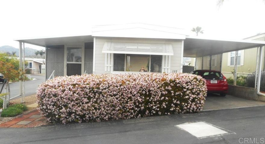 Enjoy senior life in this 55+ park.  Spacious single wide unit with added sunroom not included in the square footage. The updated kitchen is complete with gleaming stainless steel appliances, granite composite countertops and decorator back splash. The modern gas stove top, refrigerator and stylish country sink are all designed for effortless living. Plus, the stunning wood vinyl flooring adds a touch of sophistication. Enjoy entertaining friends or relaxing in the newly carpeted living room. Natural light beams through the windows here.  The master bedroom boosts 2 closets and extra storage built into the wall. The second bedroom has wood louvered closet doors and a sliding door leading to the rear yard. The sun room provides extra space that can be used as an office, craft or exercise room. The washer and dryer are also found here. These are included in the purchase. A new roof was added in 2021. Carefree Ranch offers a remodeled clubhouse with a gathering room for social events, a fully equipped kitchen, an inviting eating area, exercise room and cozy library. The heated community pool and spa are enjoyed by residents. Grocery shopping, restaurants, bank, hair and nail salons are within walking distance and  the bus stop is nearby. The park offers RV parking for a nominal fee and availability. This park is unique in that it offers the use of a guest unit for visiting loved ones for a nominal fee and availability.