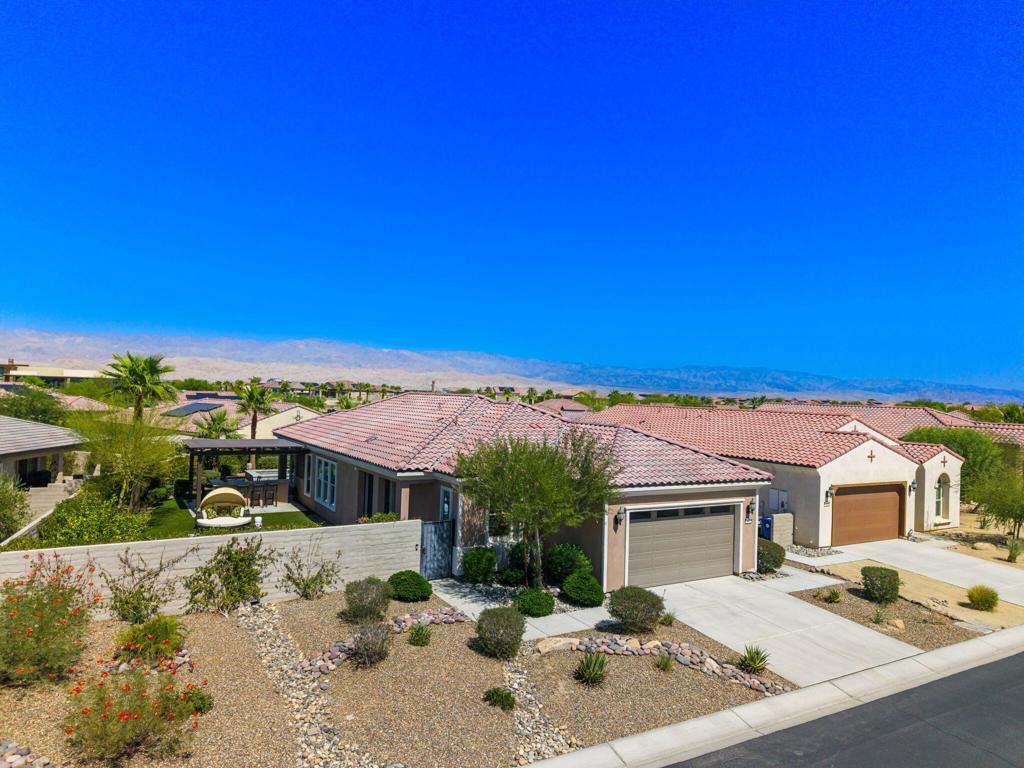 Highly Upgraded with Contemporary Interior Design by Michael Lyons and Spectacular Resort Outdoor Living on a premium lot. Enter to a stunning open Great Room and Kitchen. Gourmet Chef's Kitchen with quartz countertops, stainless appliances and social island with counter seating. Living and Dining areas with custom interiors and lighting surrounded by lots of windows and sliders for that amazing desert light. Primary Suite has access to the pool and spa terrace and features a spa bath with dual vanities and large walk-in closet. Guest suite and a den/tv room or potential 3rd bedroom or office provide great space for guests. Outside is a highly upgraded resort backyard features pool and spa with lounge seating and a covered outdoor retreat area. South facing large side yard features spectacular outdoor living area with fire pit and outdoor kitchen with counter seating has amazing south and west mountain views and lots of winter sun. One of the finest properties in Del Webb - come home to your own desert retreat!