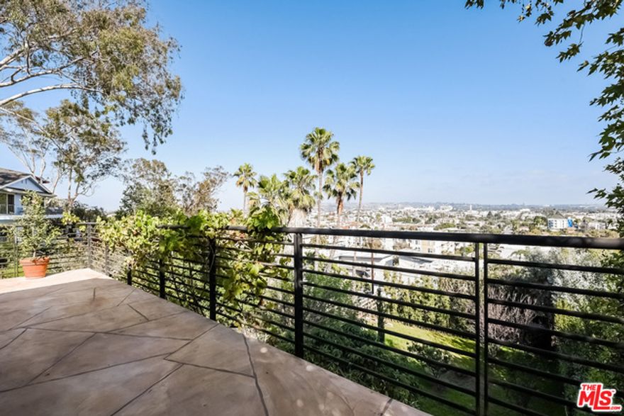 Wow, the Views! From Downtown to Palos Verdes, on the coveted "Hilltop" of Westside Village. Large and open living room w original hardwood floors, recessed lights, wood burning fireplace opens to a vaulted dining room which offers French doors to the expansive deck and breezes. A gourmet chef's kitchen features granite counters, a forged copper double sink, kitchen island, loads of storage and an open pantry. Also upstairs are 2 bedrooms and a full bathroom. Each room on the lower level has access to the impressive backyard. The media room includes a fireplace and has sliding doors to the lower patio. Next to the media room is a great flex space for office/guest/Nanny's room. Off of the flex space is a huge laundry room with exceptional storage. The private Master retreat features the ultimate, custom walk-in closet and a separate entrance to the private side yard. The backyard is peaceful and huge! Find producing grape vines, citrus trees, plus a grassy yard and kids jungle gym.