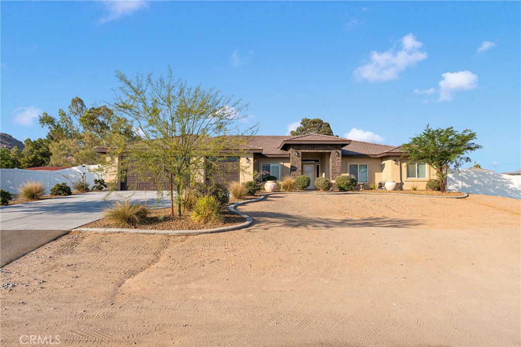 This beautifully crafted newer construction home offers the perfect blend of luxury, functionality, and energy efficiency—starting with TWO spacious master suites, each designed for ultimate comfort. PAID SOLAR!!! Both suites feature large en-suite bathrooms with custom walk-in showers enclosed in frameless glass, dual vanities, and massive walk-in closets. The main master also includes a deep soaking tub, ideal for unwinding after a long day. With a total of 4 bedrooms and 3.5 bathrooms, this contemporary split-floorplan home features an open-concept layout that centers around a massive great room, perfect for entertaining. Enjoy high ceilings, a modern fireplace, recessed lighting, and durable wood-look tile flooring throughout the main living areas. The chef’s kitchen is a showstopper—equipped with quartz countertops, a large center island, pendant and under-cabinet lighting, soft-close cabinets and drawers, a walk-in pantry, and a cozy breakfast nook, all overlooking the main living space. Situated on over ¾ of an acre in one of Apple Valley’s most desirable neighborhoods, this home offers expansive views of the entire valley and a fully vinyl-fenced backyard. The oversized 3-car garage offers plenty of space for vehicles, storage, or toys. Additional highlights include: Full-width covered patio for outdoor enjoyment Indoor laundry/mud room with utility sink and guest half bath Owned solar, tankless water heater, low-E windows, and Energy Star appliances for maximum efficiency Superior craftsmanship and attention to detail throughout. This is a rare opportunity to own a high-quality, energy-efficient home with unmatched views—a true must-see!