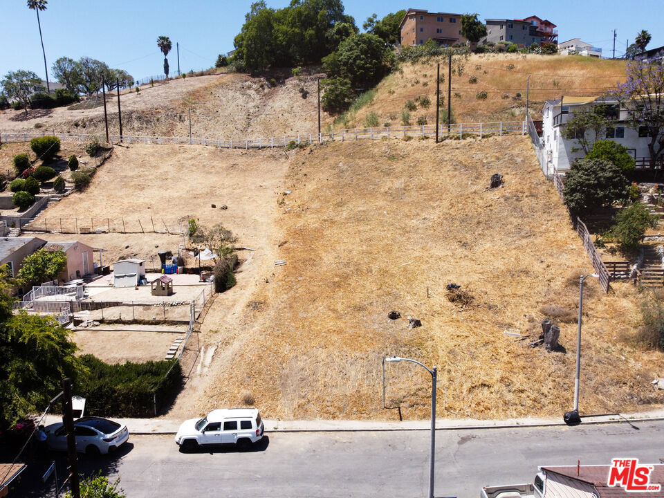 This shovel-ready project is fully permitted and RTI (Ready to Issue). Plant to build include 3 separate units on 3 stories, making it a fantastic development opportunity. 1st floor: 1-bed, 1-bath with 799 SF; 2nd floor: 2-bed, 2-bath with 1,300 SF; 3rd floor: 2-bed, 2-bath, with 855 SF. Total of 2,954 SF plus a 3-car garage accessed from Ithaca Ave. This through-lot slopes up from Ithaca at the bottom to Dartmouth Ave at the top of the hill. Nestled in the El Sereno neighborhood, this property is conveniently located to Ascot Hills & Lincoln Parks, Cal State LA, Downtown LA, markets, restaurants, and major freeways.