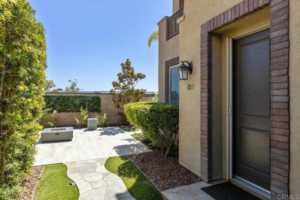 This beautiful rare end-unit home in a gated, Oceanside community offers the perfect mix of comfort, style, and convenience. Just minutes from the beach, shopping, and dining, you’ll love the easy access to everything North County has to offer. Inside, you’ll find a bright, south-facing open floor plan with panoramic views and plenty of natural light. The kitchen features modern appliances, lots of counter space, and a large island that’s great for cooking or entertaining. A first-floor bedroom and bathroom provide added flexibility for guests, multigenerational living, or a private home office. Upstairs, the spacious primary suite comes with a walk-in closet and private bathroom. Additional bedrooms are versatile - perfect for kids, guests, or work-from-home space. Step outside to an oversized, professionally designed patio yard, complete with a fountain, built-in BBQ, sink, and propane fire pit great for entertaining or relaxing. Additional features include a tankless water heater with quick hot water, an epoxy garage floor in the two-car garage and dual-zone A/C with a smart thermostat for comfort and efficiency. This home boasts $130,000 in upgrades. The gated community offers fantastic amenities, including a pool, BBQ and picnic area, and three playgrounds, along with well-kept common areas. VA approved!