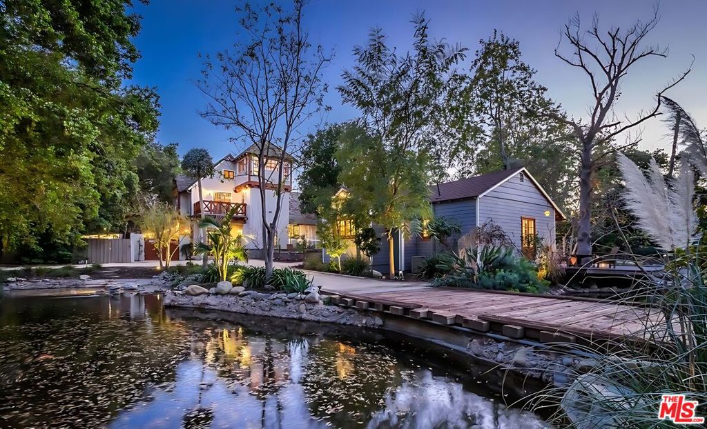Seller will consider accepting other assets as part of the purchase price including properties, crypto currency, gold and the like. Spanning nearly 2.5 acres of private, gated grounds, this extraordinary estate merges two properties into one unforgettable sanctuary in the heart of Encino. Tucked behind mature trees and a winding drive, the compound features a remarkable collection of structures, including two grand main residences, two charming guest houses, a professional recording studio, barn and bunkhouse, writer's cottage, pool and spa retreat, corrals, and a wealth of bespoke amenities. At the center, a romantic, ivy-draped courtyard with fireplace welcomes you into a world of timeless elegance. Inside, expansive living areas, a fully equipped chef's kitchen, butler's pantry, library, and pub evoke warmth and sophistication. With six bedrooms, a dedicated studio, maid's quarters, and a workshop, the estate offers both creative inspiration and luxurious comfort. Adding to its allure are three distinct guest residences including a beautifully restored mid-century home with a recording studio perfect for artists, guests, or multi-generational living. A picturesque barn, complete with bunkhouse and horse turn-out, completes the pastoral dream. Rarely does a property of this scale, privacy, and character become available. A true legacy estate designed for those who seek space, serenity, and soul. Easy to show.