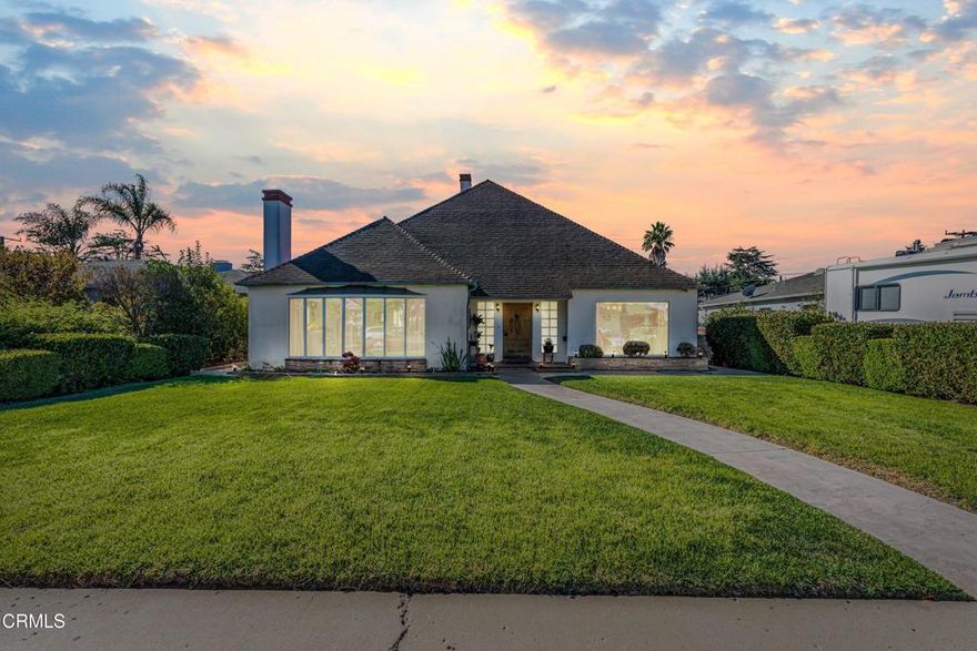 This custom-built Oxnard home offers timeless character, impressive craftsmanship, and endless potential. With 3 bedrooms, 2 full bathrooms, and 2,453 square feet of living space on a 5,662 square foot lot, this property blends vintage charm with features that were remarkably modern for its time.From the moment you arrive, the home's unique architecture and welcoming front yard set it apart. The large windows and prominent chimney enhance its inviting curb appeal. Inside, you'll find two spacious living rooms and two dining areas, offering abundant space for both relaxation and entertaining.To the left of the entry, the formal living room features oversized windows overlooking the front yard and a cozy fireplace. To the right, the dining room provides easy access to the kitchen, creating a perfect flow for gatherings.The family room exudes warmth with its rich wooden walls, brick fireplace, and built-in storage. The kitchen, complete with a vintage 1950s stove, patterned flooring, tiled countertops, and ample cabinetry, retains a nostalgic charm. A laundry chute, a rare feature for homes of this era, adds to its thoughtful design. The adjacent laundry room includes extra storage and a utility sink for convenience.Downstairs, two comfortable carpeted bedrooms share a full bathroom, while the upstairs primary bedroom connects directly to a full bath that also serves the hallway.The property also includes an oversized two-car garage with a built-in workshop and an enclosed exterior bonus room, ideal for creative projects, hobbies, or additional storage.Out back, a combination of concrete patio and grass offers a versatile space for gatherings.Conveniently located near parks, schools, and shopping centers, this one-of-a-kind property offers a blend of custom design, spacious living, and vintage charm, a true testament to craftsmanship and forward-thinking architecture.