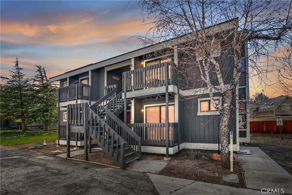 Stunning Turnkey Condo in Boulder Bay – Lake Views, Income Potential, and EV Charger! ~ Welcome to this beautifully updated and fully furnished end unit in one of Big Bear Lake’s most sought-after neighborhoods: Boulder Bay ~ With over 18 months of consistent 5-star Airbnb reviews, this upstairs condo is not just a serene mountain escape—it’s also a proven income-generating property ~ Enjoy panoramic lake views and tranquil mountain air from your private back deck, the perfect spot for morning coffee or sunset unwinding ~ This is the only unit in the entire 50-unit complex with a City- and HOA-approved Level 2 EV Charger and a dedicated EV parking space, offering unmatched convenience for you and your guests ~ Inside, you’ll love the fresh, modern feel—new paint, stylish furnishings, and thoughtful interior design throughout ~ The kitchen features granite countertops and custom Thomasville cabinetry, ideal for everything from weekend breakfasts to holiday feasts ~ Cozy up around the beautiful native rock fireplace after a day on the slopes or trails ~ Each of the two spacious bedrooms includes a full en suite bathroom, with one serving as a luxurious primary suite ~ Enjoy access to fantastic community amenities, including a sparkling pool and a relaxing jacuzzi—perfect after a day of adventure ~ Whether you’re seeking a high-performing short-term rental, a weekend retreat, or your own slice of mountain paradise, this is the rare Big Bear opportunity that checks all the boxes.