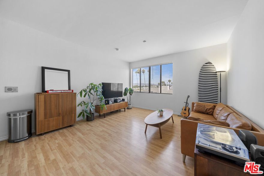 Welcome to a bright and airy top-floor residence located in one of Koreatown's most dynamic and centrally connected neighborhoods. This spacious 2-bedroom, 2-bathroom condo offers thoughtful design, functional flow, and an elevated sense of livability, all complemented by sweeping views of the iconic Hollywood Sign. Inside, you'll find high ceilings and no upstairs neighbors, giving the home a peaceful, open feel. The north-facing living room is filled with natural light and opens to stunning vistas, while the adjacent dining area and kitchen create a seamless environment for everyday living and entertaining. The kitchen features a charming passthrough window perfect for serving breakfast or hosting dinner parties and is equipped with a Frigidaire range, LG refrigerator, and GE dishwasher. The first bedroom also enjoys soft north-facing light and a generously sized closet for added storage. A full guest bathroom includes a modern stand-up shower. The south-facing primary suite offers privacy and its own en-suite bathroom, completing this smart and well-laid-out home. Additional highlights include two dedicated parking spots, abundant guest parking, and access to the community pool. The community laundry room is conveniently located on the same floor. Right outside your door, you'll find easy access to some of LA's most iconic destinations. Ralphs, The Wiltern, and the charming shops and cafes of Larchmont Village are all nearby, along with Koreatown's renowned restaurants, cafes, and nightlife. This is city living with an easygoing rhythm, right in the heart of it all. Don't miss this rare opportunity to own a top-floor unit with natural light, thoughtful updates, and a prime location in one of LA's most desirable neighborhoods. Come experience this exceptional top-floor corner unit and see what makes it a standout opportunity in Koreatown.
