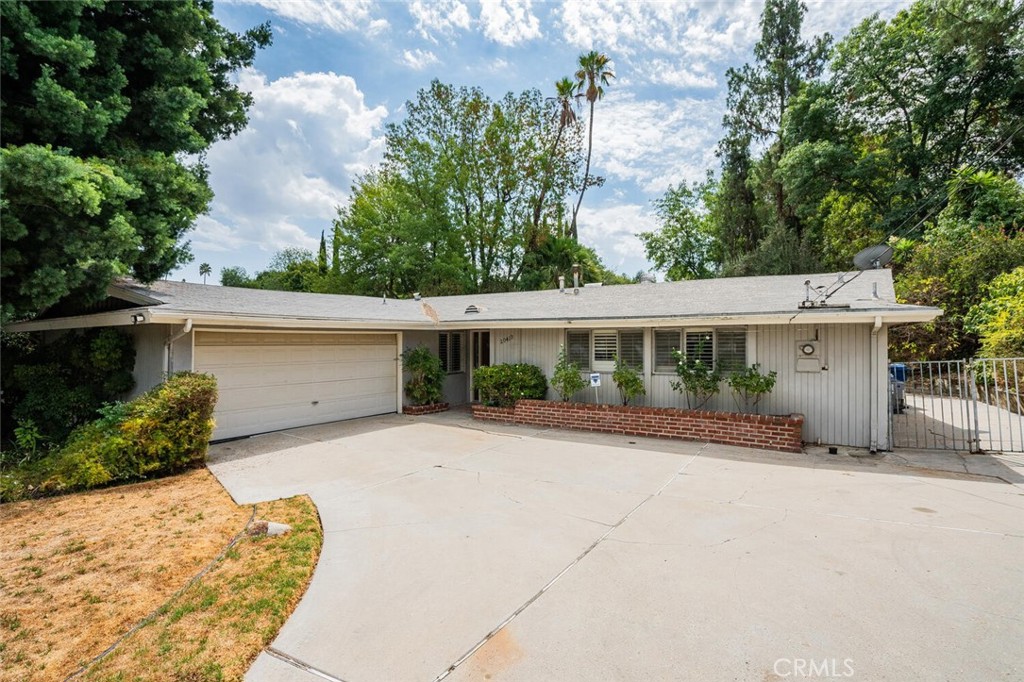 First time on the market! Welcome to 20410 Miranda Street, a three-bedroom, two-bathroom single-story pool home in the desirable Carlton Terrace neighborhood of Woodland Hills. Lovingly owned by the original family, this residence offers timeless character and endless potential.
The living room is highlighted by vaulted ceilings, a classic brick fireplace, and sliding glass doors that open to a covered patio leading to a sparkling pool. The backyard is surrounded by lush greenery, private and perfect for indoor-outdoor living. The kitchen features a charming bay window and breakfast nook, while the primary suite offers its own en-suite bathroom with a shower. Additional features include central heat and air, a two-car attached garage, and a quiet location in a well-loved neighborhood.
Set on an expansive 8,754 sq. ft. lot, the property has plenty of room to create your own private oasis. Ideally situated near shopping, transportation, Kaiser, Warner Center, Westfield Village, and the new and vibrant LA Rams Village, this home combines convenience with potential. A rare opportunity to reimagine a classic Woodland Hills property into your dream retreat.