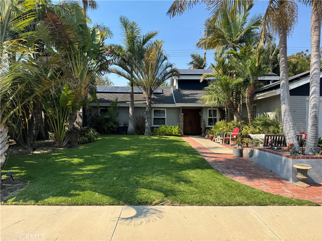 Welcome to 1956 Flamingo!! This property is perfectly situated in the highly sought-after LOWER BIRDS neighborhood of Mesa Verde. The front of the home is beautifully landscaped and lined with swaying tropical palm trees, this home feels like your own slice of paradise. As you enter, you're welcomed into the spacious kitchen and dining area, the heart of the home, offering plenty of room to cook, gather, and entertain. Step into the inviting living room, where a cozy fireplace and gorgeous wood-trimmed French doors that open to your TROPICAL BACKYARD RETREAT. Designed for relaxation and entertaining, the outdoor space features a sparkling salt water pool, above-ground spa, multiple seating areas, and lush landscaping with soaring bamboo and mature palm trees creating the ultimate private escape. Upstairs, the expansive primary retreat spans the entire second floor, boasting soaring wood ceilings with stunning exposed beams, generous closet spaces, and room for a sitting area where you can unwind to the soothing sound of backyard fountains. The home also includes a secondary primary suite on the main level with a beautifully remodeled ensuite bathroom, plus two additional bedrooms and a guest bath—perfect for family and friends. This is more than a home—it is a true slice of paradise in one of Costa Mesa’s most desirable neighborhoods. ***PROFESSIONAL PHOTOS COMING SOON***