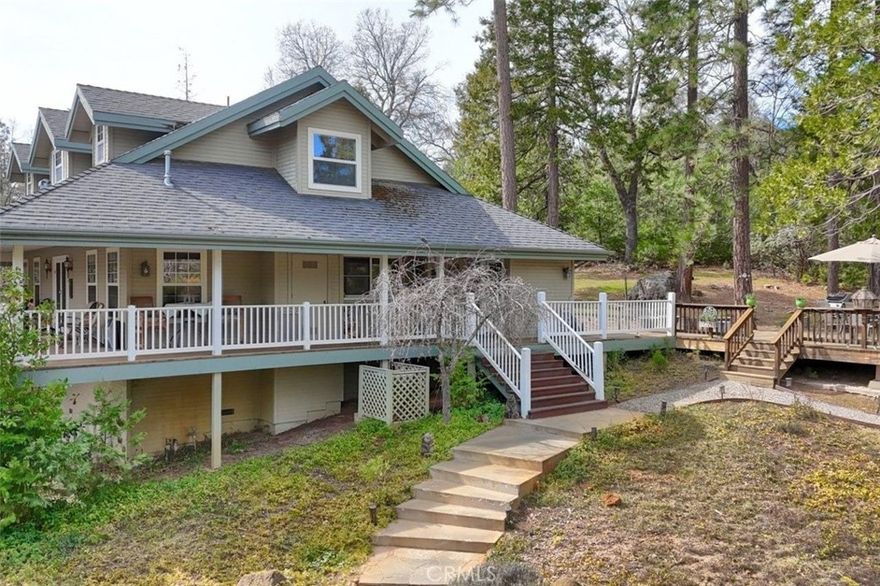 Located in a beautiful neighborhood that borders National Forest land, you will find this gorgeous custom 3 bedroom, 2 1/2 bath home with a detached garage and 3.89+/- lovely peaceful acres to enjoy all of the wildlife and birds singing from your covered front porch or while you relax on the covered back deck!  The large living room offers picture window views and a wood stove with easy flow to the den/office area where you'll find more views!  The dining room has a coffered ceiling with ceiling fan and lots of space for entertaining.  The kitchen is definitely the heart of the home with a breakfast area with a bay window, extra Corian counter top space, a center island, cabinet space, built-in Sub Zero refrigerator and even a pass thru window to the back deck to make those outdoor barbecues a breeze!  Also on the first floor are a half bath, laundry room  and the primary suite with a larger coffered ceiling, ceiling fan, walk-in closet and an adjoining bath with 2 sink vanity, shower and a built-in linen closet.  The upstairs has 2 guest bedrooms and a bath.  Out on the back deck you will enjoy the fresh air, wonderful mountain views, majestic tall trees and there are hot tub hook-ups ready to go.  Take a stroll to the detached 2 car garage and you'll find a one of a kind rock wall with steps from the yard to the parking area.  Great Oak hardwood flooring throughout the home except the bedrooms that are carpet.  Beautiful views are everywhere you look!  There is truly so much to see and appreciate here that you'll find it hard to leave!  Close to Bass Lake or Manzanita Lake for outdoor fun and it is an easy commute to Fresno.