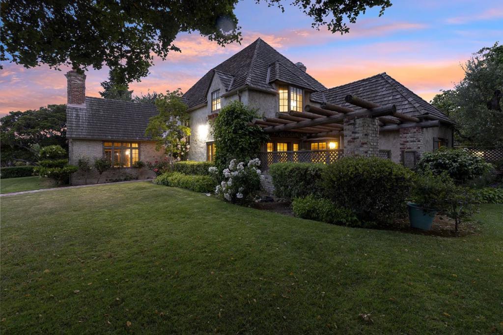8 Los Laureles Ave, located in Maple Park, South Salinas, is a historic property exemplifying the architectural heritage of Monterey County. Designed by H. Roy Kelley for Bruce Church and built in 1929, the mansion reflects the affluence and optimism of the Roaring Twenties. The French Tudor style mansion is approximately 5300 square feet and exudes charm, warmth and sophistication. The structure handsomely occupies an amazing .55+ acre corner lot with an oak tree perfectly positioned in the front yard nearly a century ago! With an incredibly private back yard, and a 4-car garage with a gated driveway, it is hard to believe this oasis is in the middle of Monterey Counties largest city. Highlights of this recently updated one-of-a-kind property include an amazing living room with a huge fireplace and soaring open beamed ceilings, a spacious modern kitchen, an adjoining family room with a raised fireplace, 7 bedrooms, 5 and one-half baths, an attached guest unit, a large basement, several private courtyards and much more. Historically, 8 Los Laureles has been a cherished residence for prominent agricultural families in the Salinas Valley, presenting a valuable opportunity to acquire a significant piece of local history.