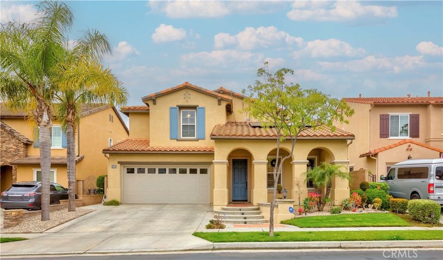 Welcome to 2551 Holly, located in the sought-after Aspens neighborhood within the picturesque, gated Turnleaf community. Ideally nestled at the end of a quiet cul-de-sac, this home boasts one of the community’s largest floor plans. Step inside and be greeted by a dramatic spiral staircase and soaring cathedral ceilings in the formal living room, creating an immediate sense of space and elegance. Abundant natural light fills the home, enhancing its warm and inviting ambiance. The well-designed layout flows effortlessly through the main level, where the formal dining room connects to a butler’s pantry and into a bright, spacious gourmet kitchen, featuring a center island ideal for meal prep or casual dining, generous cabinetry offering ample storage, and sophisticated granite countertops with a matching backsplash. The open layout seamlessly connects to the family room with a cozy fireplace, creating the perfect setting for both everyday living and entertaining. Tucked away on the main floor is a private bedroom with an adjacent full bathroom and walk-in shower, ideal for guests or multigenerational living. At the rear of the home, step into your private, low-maintenance backyard featuring a partially paved area that’s perfect for hosting gatherings or enjoying relaxed evenings. Upstairs, you’re first greeted by a versatile loft-style office or bonus area, complete with built-in bookshelves — ideal for working or studying from home. Just beyond, the luxurious primary suite offers dual walk-in closets, his and hers sinks, a dedicated vanity area, an oversized soaking tub, and a separate walk-in shower. Two additional bedrooms and another full bathroom complete the upper level. Each bedroom includes a ceiling fan for added comfort. Additional highlights include a water softener system for enhanced water quality and a solar panel system to help reduce energy costs — offering both efficiency and sustainability. Enjoy resort-style amenities, including a sparkling pool and spa, scenic walking trails, a playground, and secure gated access. Children attend the highly rated Beechwood K–8 School and benefit from access to Fullerton’s top high schools, including Troy High and Fullerton Union. Close to downtown Fullerton’s dining and entertainment, Fullerton Golf Course, St. Jude Medical Center, The Loop biking and hiking trails. 2551 Holly offers the perfect blend of lifestyle, comfort, and location. Don’t miss the opportunity to own this rare gem in Turnleaf.