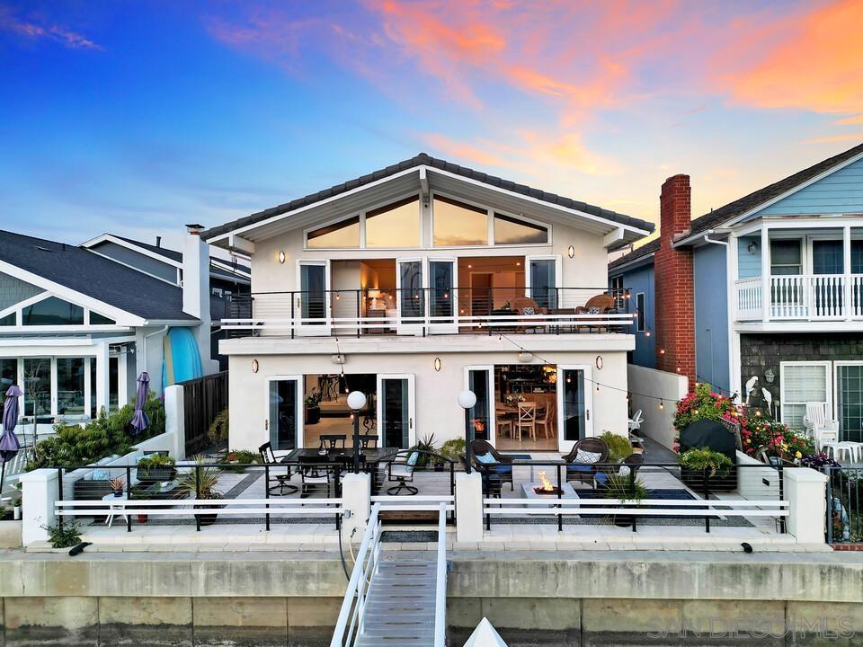 Spectacular waterfront living in the Coronado Cays! Enjoy stunning westerly views from this beautifully updated custom home featuring private wharfage for two 62-foot yachts (dock & pillars replaced in 2016). This spacious and airy residence offers high vaulted ceilings, travertine flooring throughout, and seamless indoor-outdoor flow through elegant French doors. The modern kitchen boasts granite countertops, custom cabinetry, and designer lighting. The tranquil primary suite showcases a spa-like bath with a walk-in shower and personal sauna, generous closet space, and a private balcony perfect for sunset views. Additional highlights include a first-floor bedroom, sophisticated lighting and sound systems throughout, custom railings and built-ins, and a 3-car garage. A rare opportunity to own a luxurious waterfront retreat in an exclusive location!