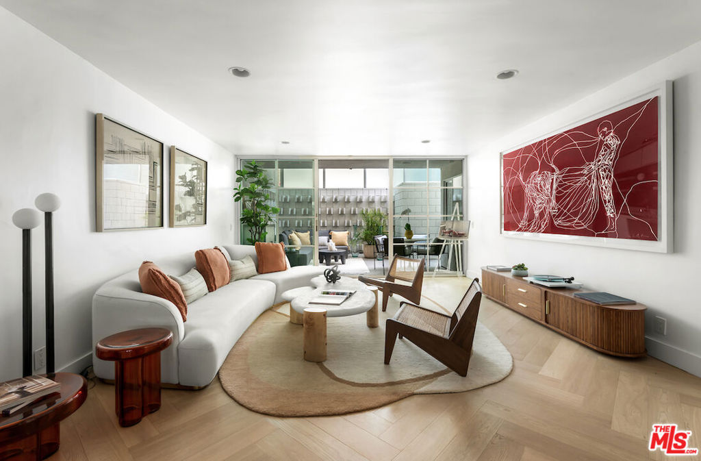 Experience Mid-Century Modern luxury steps from the Sunset Strip in Prime West Hollywood! This 2-bed, 2-bath residence blends timeless design with modern upgrades across 1,109 square feet, plus a rare large private patio, all in a stunning building designed by renowned architect Frank P. Schneider, AIA. Located on the quiet rear side of the building, this corner unit showcases clean architectural lines, a seamless open layout, and a floor-to-ceiling glass door that opens onto the largest private patio in the building, an outdoor sanctuary delivering unmatched space and tranquility. The updated kitchen features stainless steel appliances, granite countertops, and plenty of storage. Both bathrooms have been thoughtfully renovated with upgraded vanities, high-end fixtures, and state-of-the-art bidets. Throughout the home, new wide plank herringbone hardwood flooring elevates the aesthetic. Residents also enjoy access to a rooftop deck with panoramic city and ocean views. Enjoy this quiet and tranquil condo home on a peaceful street, just steps from all the action on the iconic Sunset Strip. Walk to Sunset Tower, Chateau Marmont, the Pendry and LA's best in dining, shopping and nightlife. Come experience this architecturally significant, extensively upgraded, and ideally located condo home for yourself.