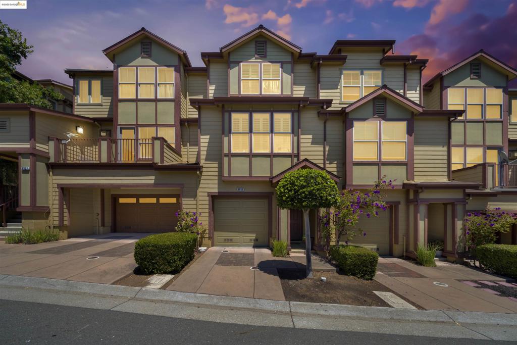 Discover sophisticated urban living in this stunning, move-in-ready townhome that masterfully blends contemporary elegance with everyday functionality. The ground level features a secure two-car tandem garage with workshop space, while the main floor showcases an exceptional open-concept design intertwining the kitchen, breakfast bar, dining area, and living room with rich luxury vinyl plank flooring throughout. The chef-inspired kitchen includes granite countertops, professional-grade gas cooking, stainless steel appliances, and custom shaker cabinetry with designer hardware. A versatile bonus room offers endless possibilities as a home office, entertainment space, or guest suite, complemented by a convenient full bathroom. Step outside to your private oasis—a level, fenced patio with premium artificial turf, perfect for entertaining, pet play, or relaxation. Upstairs, two luxurious en-suite bedrooms each feature spacious walk-in closets, while the primary suite bathroom serves as a spa-like retreat with soaking tub, separate shower, & dual vanity. This exceptionally low-fee HOA community offers a range of resort-style amenities, including a fully-equipped fitness center, elegant clubhouse, dog parks, & multiple playgrounds, creating the perfect environment for elevated living!