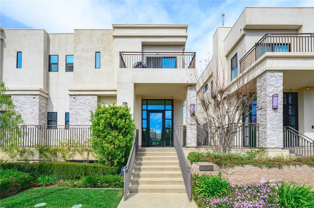 This beautifully designed three-bedroom, two-and-a-half-bath residence offers over 1,800 square feet of thoughtfully crafted living space. The open-concept floor plan is perfect for entertaining, featuring a gourmet kitchen equipped with top-of-the-line GE Monogram stainless steel appliances, elegant stone countertops, Italian glass-faced designer cabinetry, a mosaic glass backsplash, and dual stainless steel sinks. The expansive island, complete with a commercial-grade cooktop and overhead venting system, makes meal preparation effortless.
The inviting living room showcases a cozy gas fireplace, while wide-plank laminate flooring extends throughout the home, enhancing its modern aesthetic. A striking glass wall and floating staircase lead to the upper level, where natural light pours into every room.
The luxurious master suite boasts an oversized walk-in closet and a spa-like bathroom with a separate shower and soaking tub. Step onto the private balcony adjacent to the master suite and unwind with your favorite drink as you take in the sunset. The two additional bedrooms are generously sized, each offering ample closet space.
Thoughtful designer details include high-end electrical and plumbing fixtures, Hunter Douglas custom fabric window treatments with automated controls, and prewiring for A/V and security systems.
The rear patio is a private oasis featuring tiled flooring, synthetic turf, and drought-resistant landscaping. The lower level provides direct access to a spacious two-car side-by-side garage, as well as a dedicated laundry area. Additional guest parking is available within the secure gated driveway.
This prime location offers walking-distance convenience to premier shopping (TJ Maxx, Vons, CVS, Nordstrom Rack, Walgreens and Coming Soon Trader Joe's...etc), dining, medical offices, and effortless freeway access.
Welcome to a home that perfectly balances luxury, comfort, and convenience!