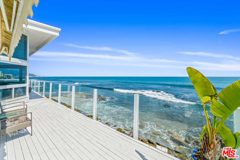A rare oceanfront opportunity on Malibu Road with approx. 75' of beach frontage, pool and spa and a separate guest house! Enter this charming 4 bedroom, 4 bathroom property through a private gated entry into a walled courtyard surrounded by overhanging trees with pool and ocean view spa, built-in BBQ, wonderful entertaining areas and stairs to beach. Enjoy stunning ocean views from the spacious living/dining areas with high ceilings, floor-to-ceiling windows, a fireplace, kitchen and wrap around ocean view deck perfect for entertaining and oceanfront dining. The master suite is oceanside and opens to the deck. The other two bedrooms offer ensuite bathrooms, one has double doors leading to the pool, the other has a fireplace and access to an ocean view deck. There is a fabulous separate guest house above the garage with one bedroom, one bath, kitchen, ocean view deck and private entrance. Includes plans and permits in process for remodel.