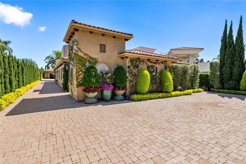 Welcome to 20382 SW Cypress Street, a rare opportunity to own nearly half an acre in the heart of Newport Beach. This expansive 19,800 square-foot lot is home to a stunning single level 4,220 square-foot residence offering four spacious bedrooms and four bathrooms, designed for both comfortable living and grand entertaining.
Inside, the home features open, light-filled living spaces with a seamless flow to the outdoors. The generous kitchen, dining, and living areas are complemented by large windows and doors that invite natural light and frame views of the sprawling grounds.
The backyard is a private retreat, complete with a sparkling pool and multiple lounging and entertaining areas—perfect for enjoying Southern California’s indoor-outdoor lifestyle year-round.
Car collectors and hobbyists will appreciate the 12-car garage, an incredibly rare feature in Newport Beach that provides unmatched storage and flexibility.
With its premier location, expansive lot, and exceptional amenities, this property offers a unique blend of space, privacy, and convenience—just minutes from the beach, shopping, and top dining.