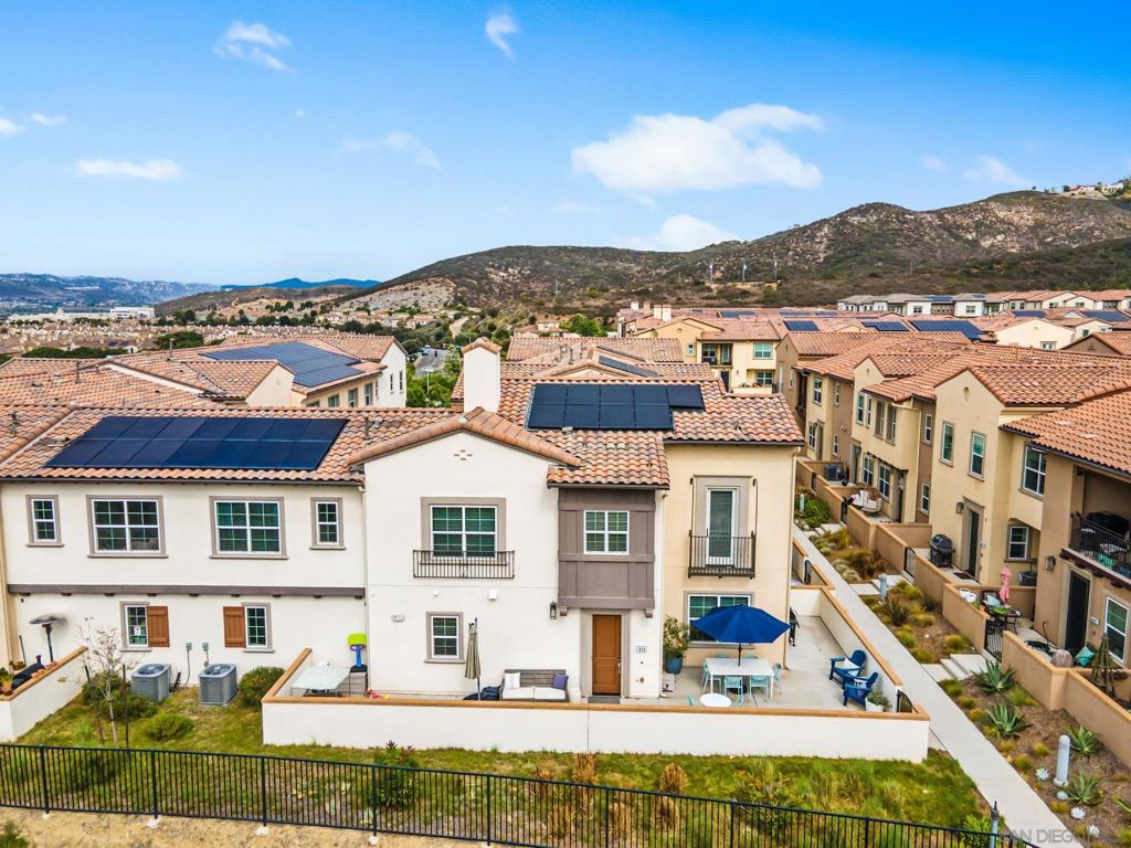 Corner Lot with VIEWS! Located within the private hilltop community of Skyhaus at Rancho Tesoro in San Marcos. This beautiful corner-unit home, built in 2021 by CalWest, is filled with natural light and modern charm. The open floor plan highlights a stylish kitchen with crisp white cabinetry, stainless steel appliances, and a center island with breakfast bar seating that flows into the living room. Upstairs, the spacious primary suite offers a walk-in closet, spa-like en-suite bath, and a Juliette balcony that welcomes in fresh breezes while framing hillside views. Additional features include energy-efficient solar, a private patio with mountain views, and an attached two-car garage. Nestled within the gated community Skyhaus, residents enjoy resort-style amenities including a sparkling pool, playground, and scenic trails, with a nearby reservoir for fishing and nature walks. Served by highly rated Double Peak K-8 and Mission Hills High School, this home is the perfect blend of comfort, community, and convenience. Rancho Tesoro’s preferred setting south of Highway 78 means residents are easily connected to the 15 Freeway, coastal Carlsbad, business centers, and favorite destinations for fun and leisure.