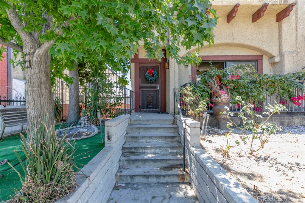 Welcome to 14840 Parthenia St, Unit 19 a spacious and well-kept 3-story townhouse in Panorama City. This home features 3 bedrooms all located upstairs, even though public records show 2. The main bedroom has its own private balcony with peaceful neighborhood views. There are 2 bathrooms total, 2 full upstairs and 1/2 downstairs. The second floor offers a large living room with a cozy fireplace, a dining area, and an open kitchen, all with beautiful black stone flooring. A sliding door leads to the front porch, bringing in natural light and fresh air. The first floor includes a 2-car garage with a bonus storage area and direct access to the home. Enjoy the community pool just a short walk away and the beautifully landscaped grounds. Conveniently located near Panorama Mall, public transportation, Seupulveda Recreation Center, and the 405 Freeway, this home offers both comfort and easy access to everything you need.